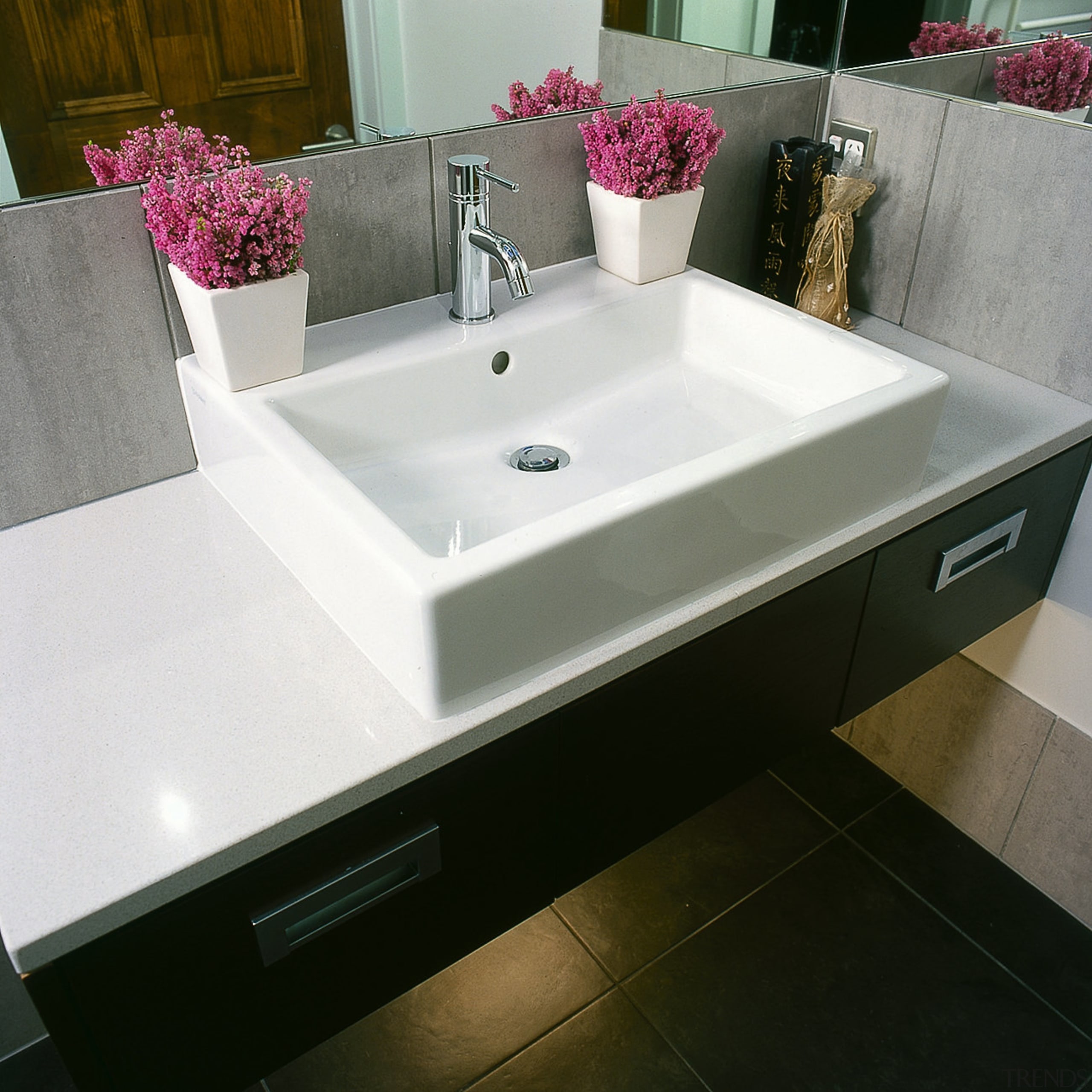 The detail of a basin in an ensuite bathroom, bathroom sink, ceramic, countertop, floor, plumbing fixture, product design, sink, tap, tile, gray, black