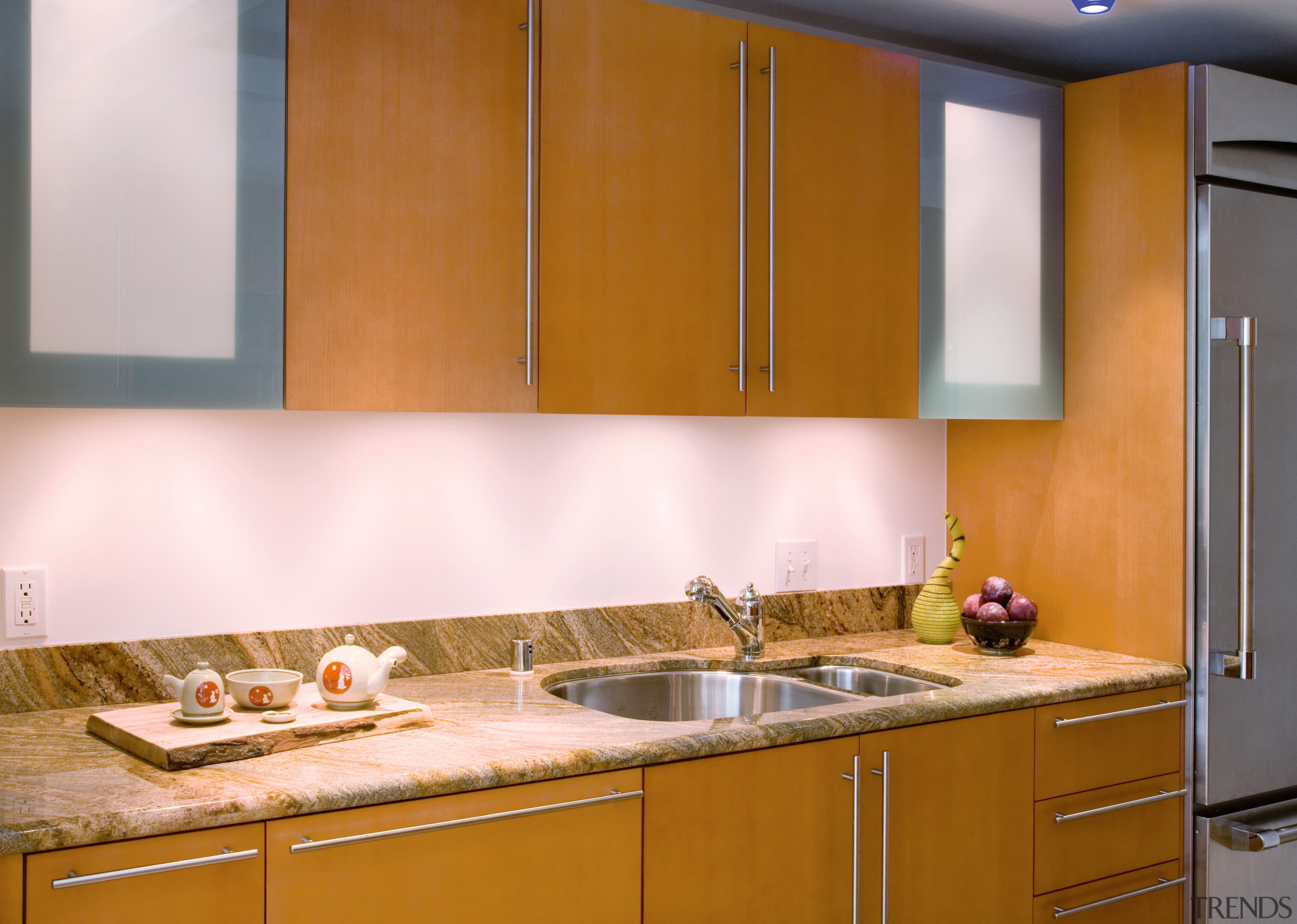 A view of this kitchen featuring stained timber cabinetry, countertop, interior design, kitchen, room, sink, under cabinet lighting, brown, white