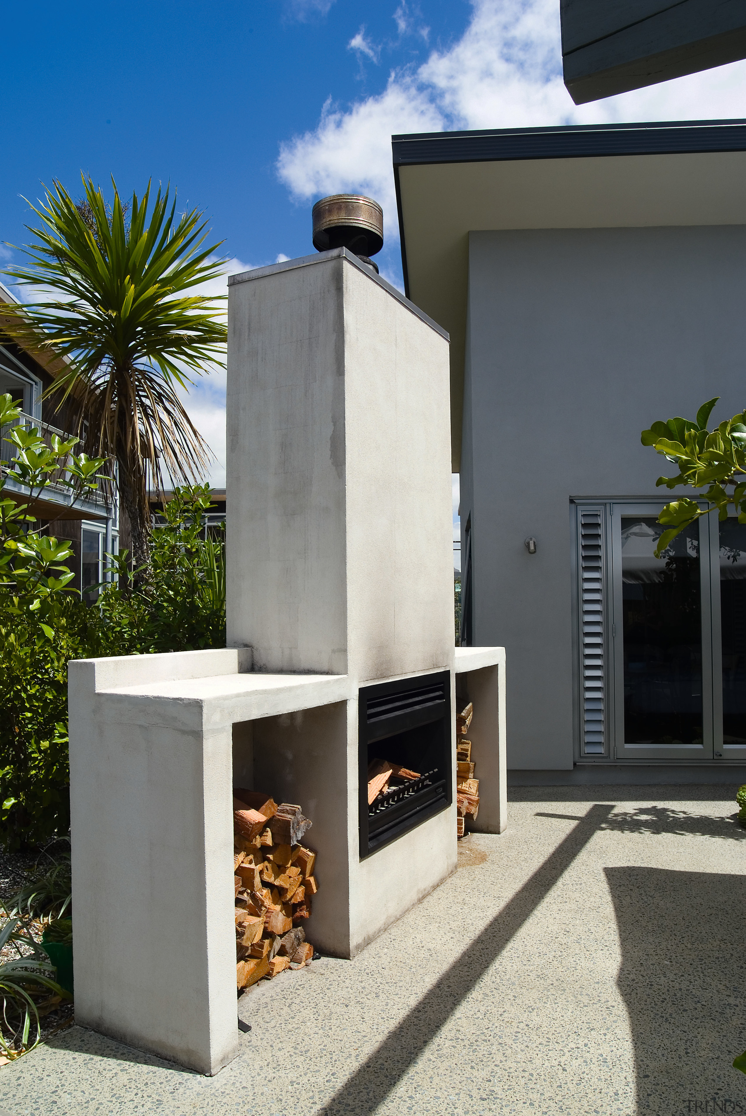 View of the precast fireplace  and exposed house, gray