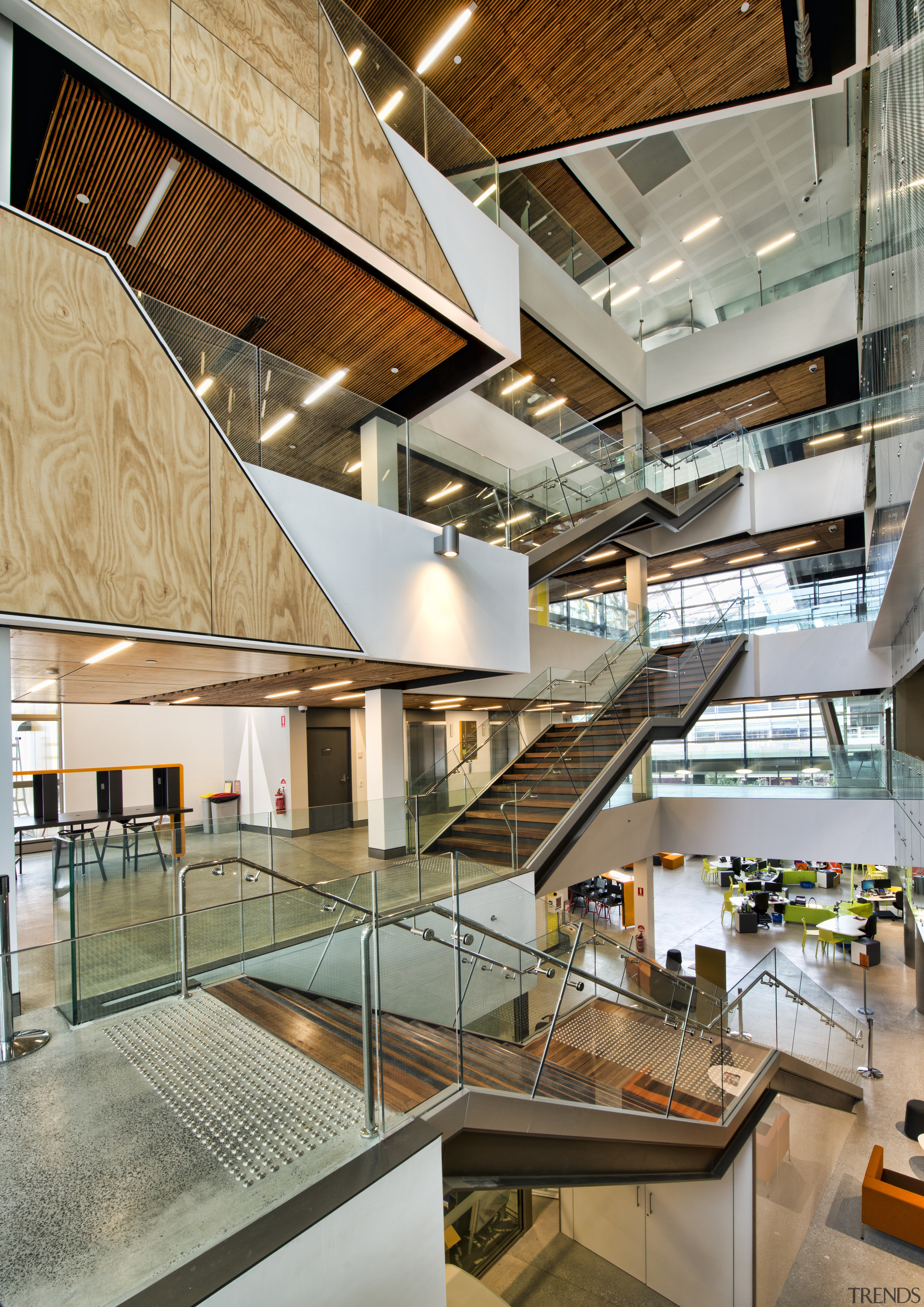 A grand atrium forms a vertical spine on architecture, daylighting, interior design, lobby, stairs, gray, brown