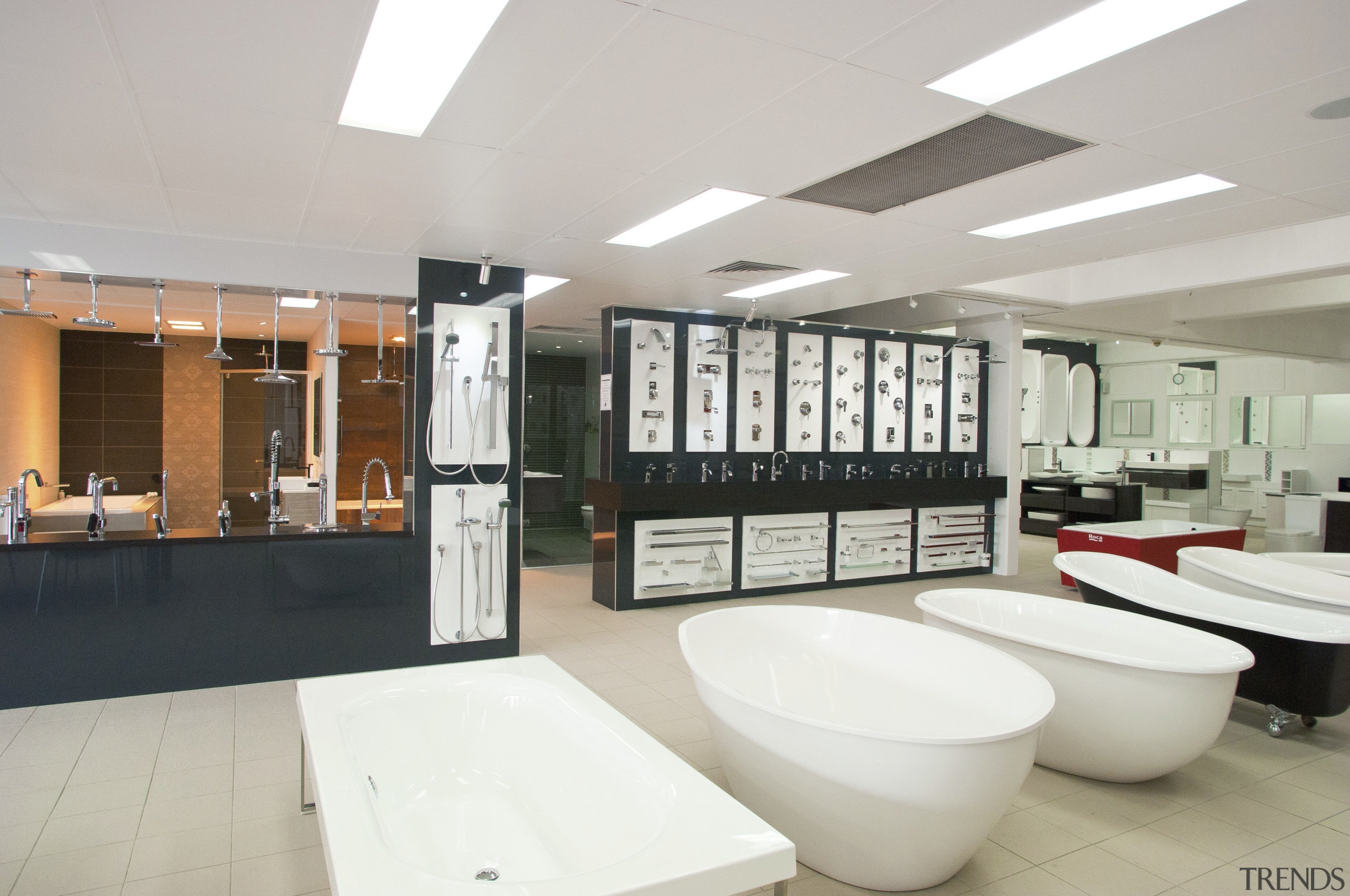 shop floor showing range of bathtubs, different angle interior design, gray