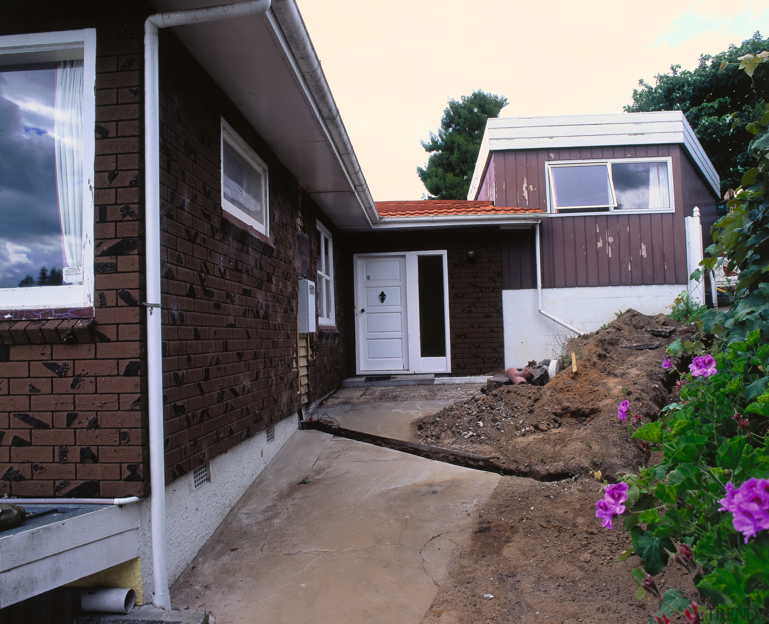 A view of the entrance way before the architecture, backyard, cottage, facade, home, house, property, real estate, residential area, roof, siding, window, yard, black, gray