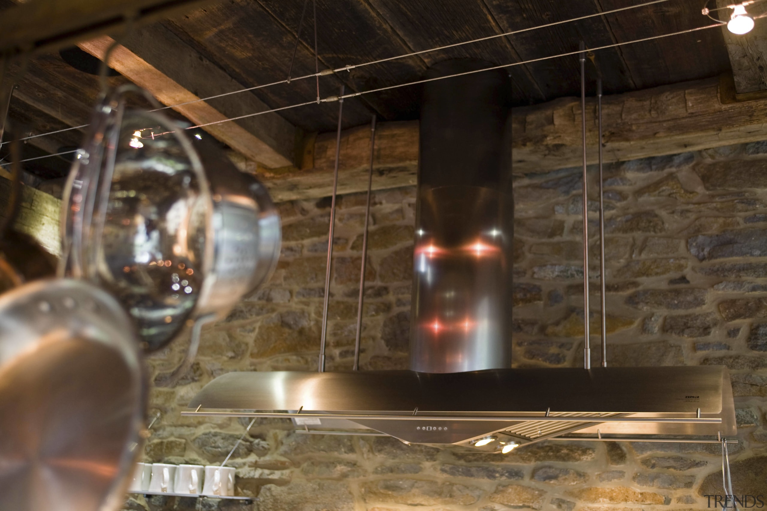 Seen here is a kitchen designed by Jill glass, lighting, wood, brown