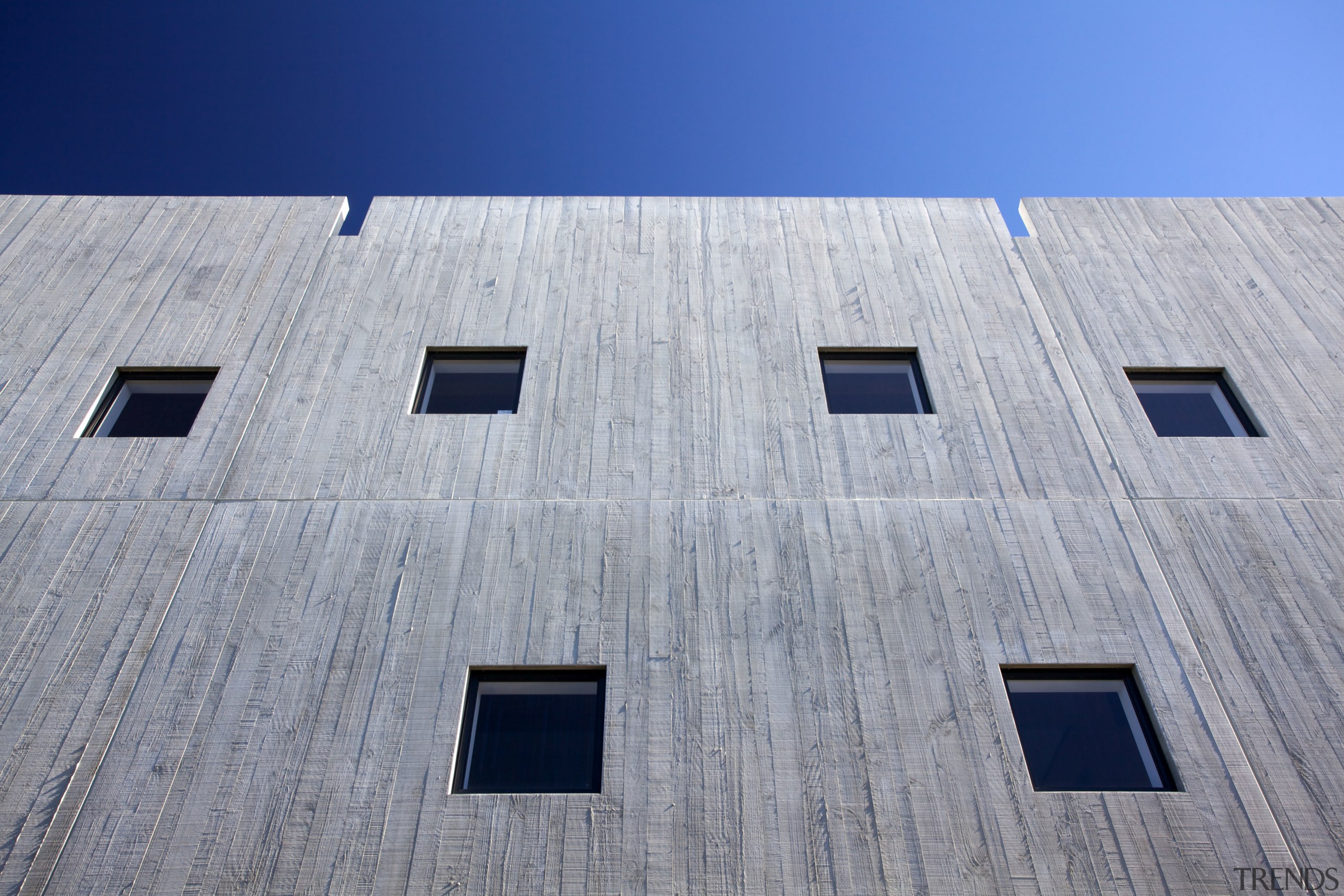 The south-facing firewall of Young Hunter House features architecture, building, daylighting, daytime, facade, house, line, roof, sky, structure, wall, window, gray, blue