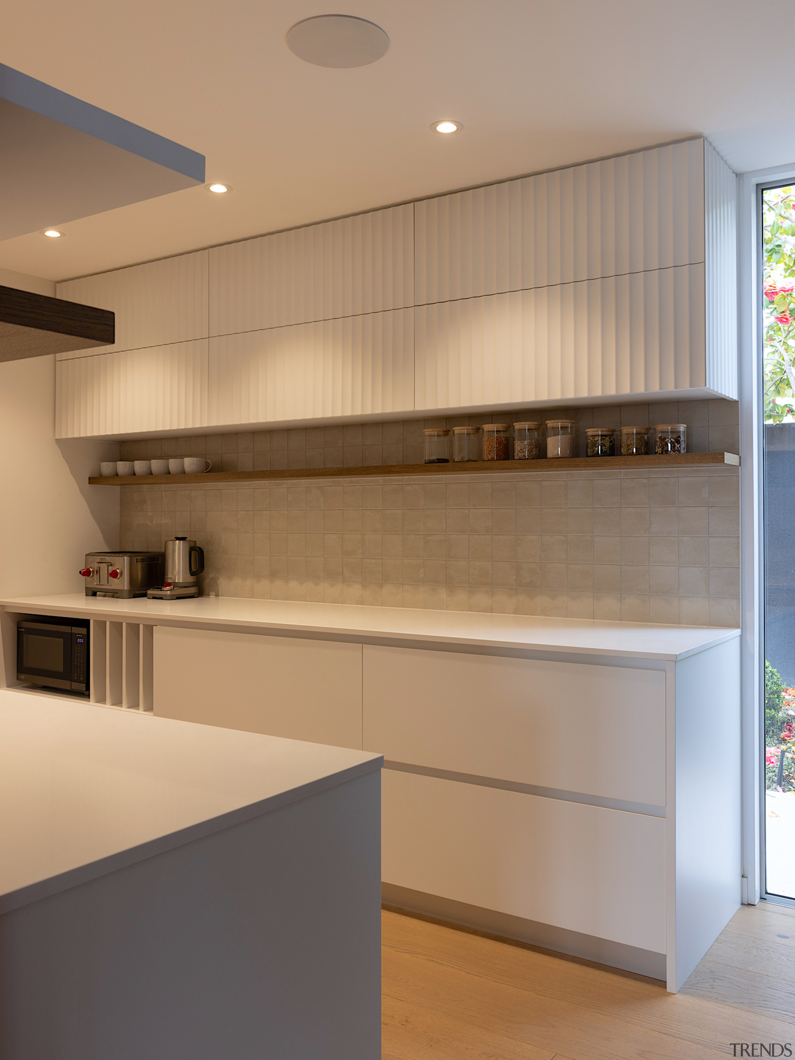 Fluted upper cabinets and a tiled splashback in 