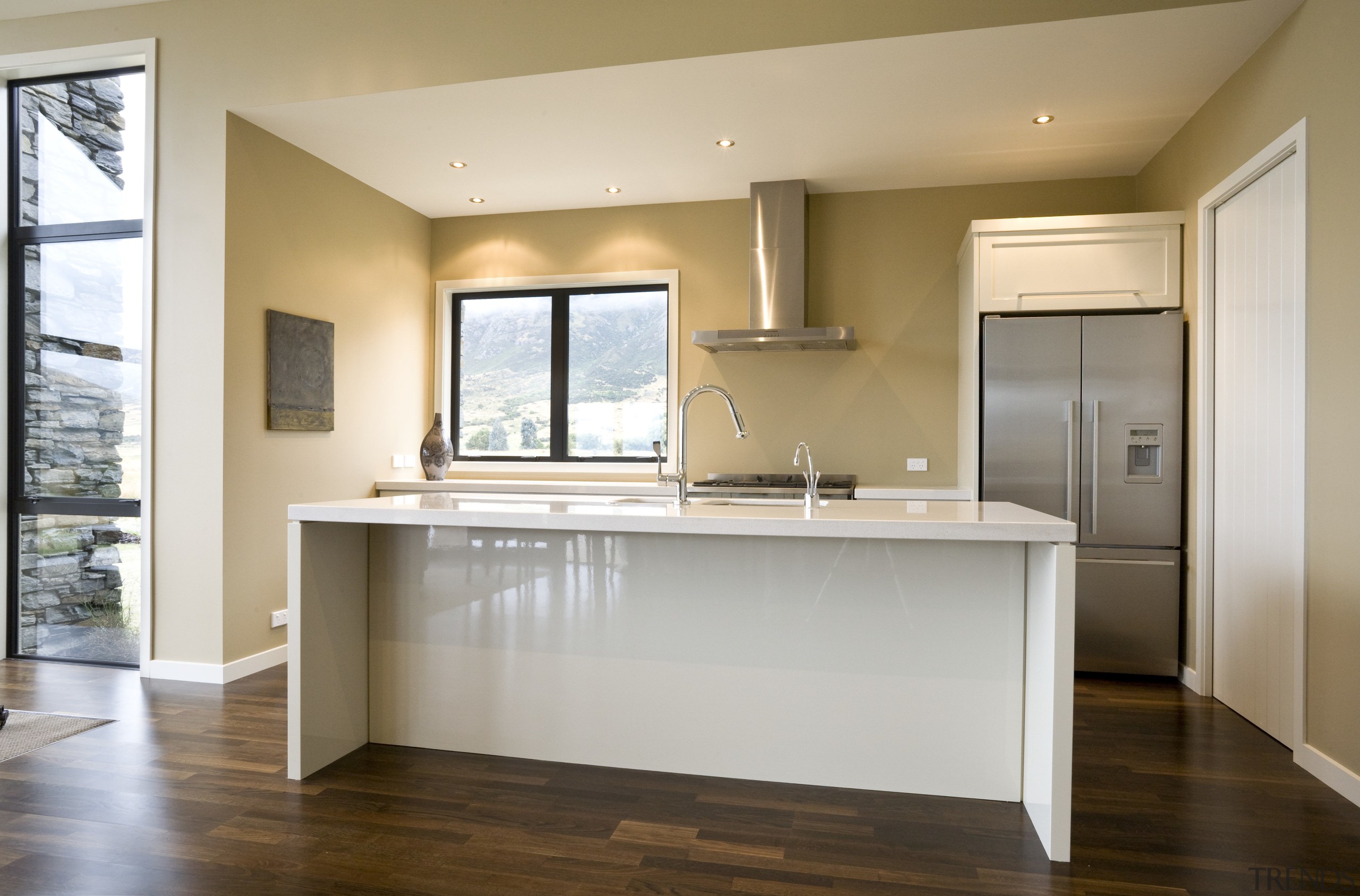 view of a show home kitchen where the cabinetry, countertop, floor, flooring, hardwood, home, interior design, kitchen, real estate, room, window, wood flooring, gray, brown