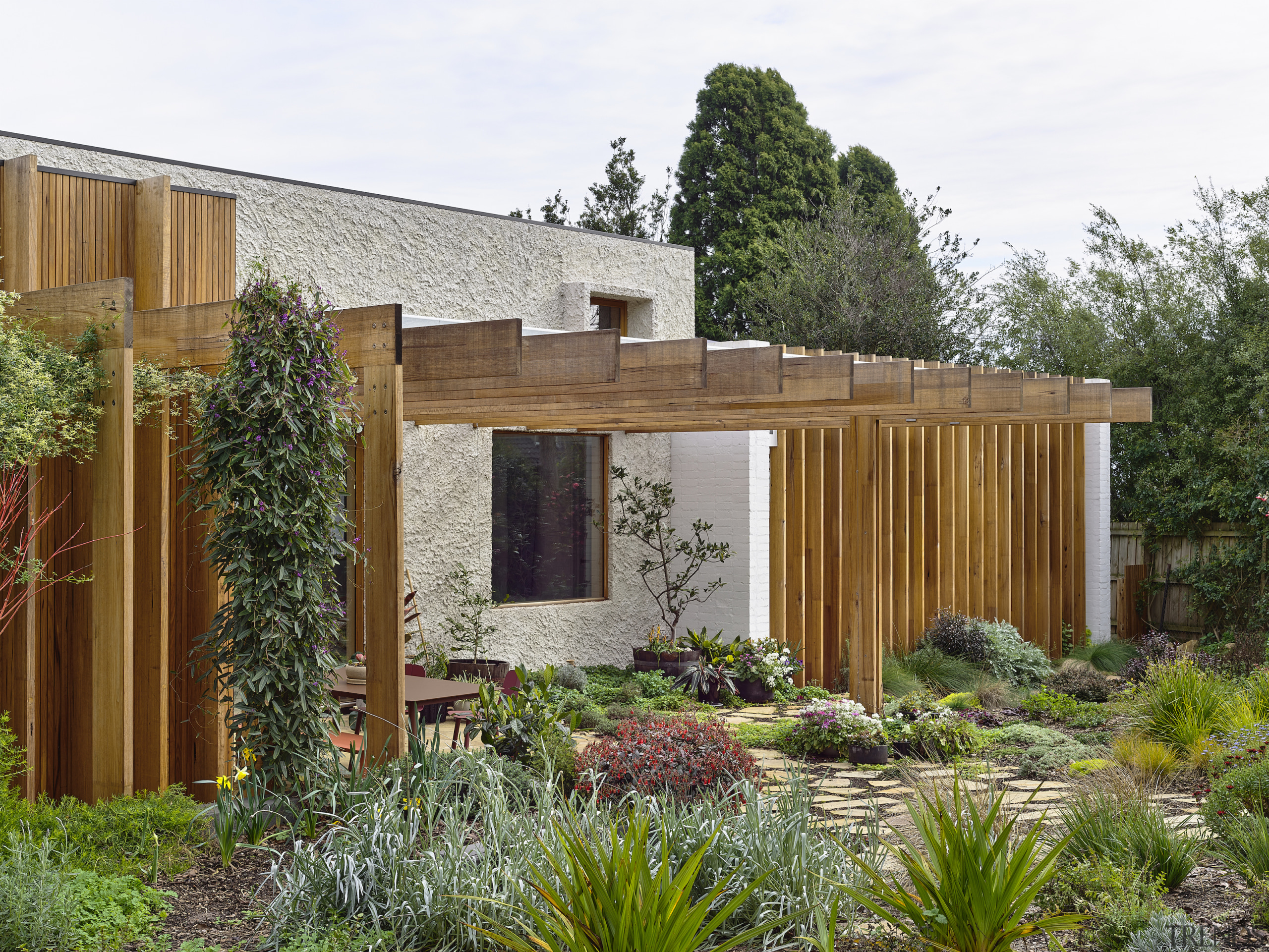 The pergola at the side of the home. 