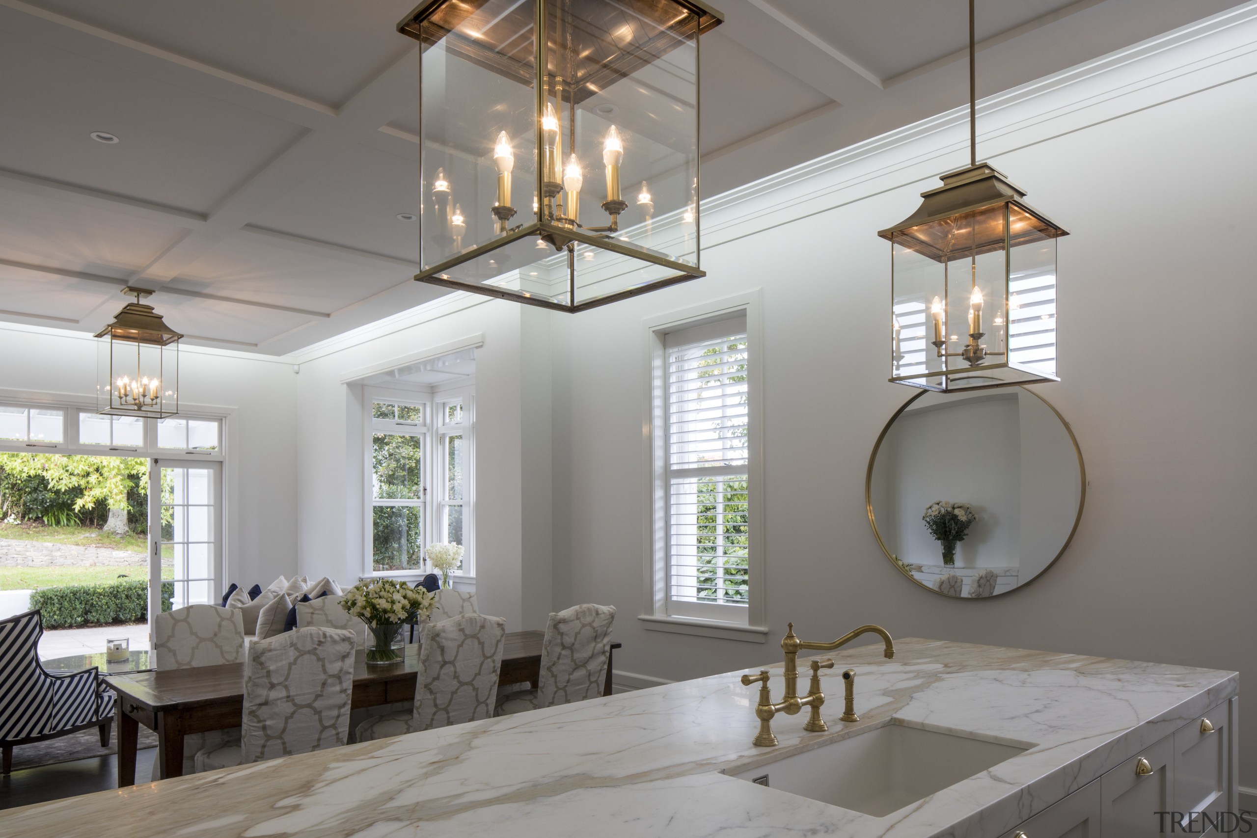 The informal living spaces run from kitchen to ceiling, daylighting, dining room, home, interior design, light fixture, lighting, table, window, gray