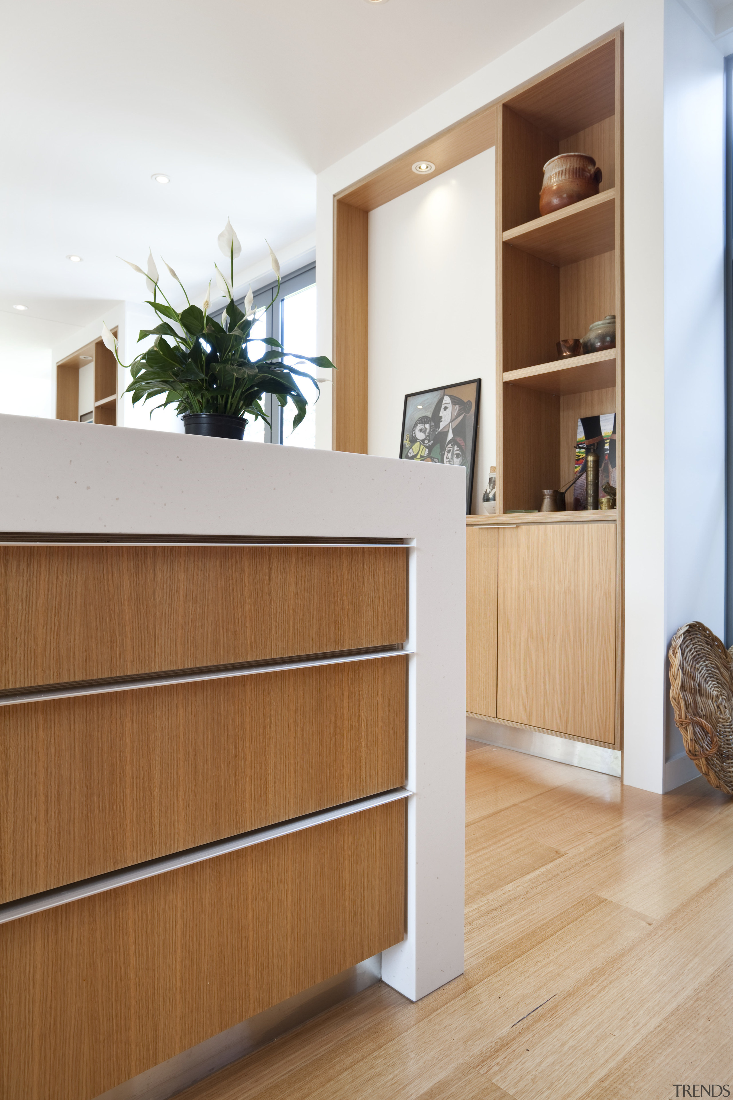 View of kitchen island drawers with wooden flooring. bookcase, cabinetry, chest of drawers, drawer, floor, flooring, furniture, hardwood, interior design, plywood, shelf, shelving, sideboard, wood, wood flooring, white, brown