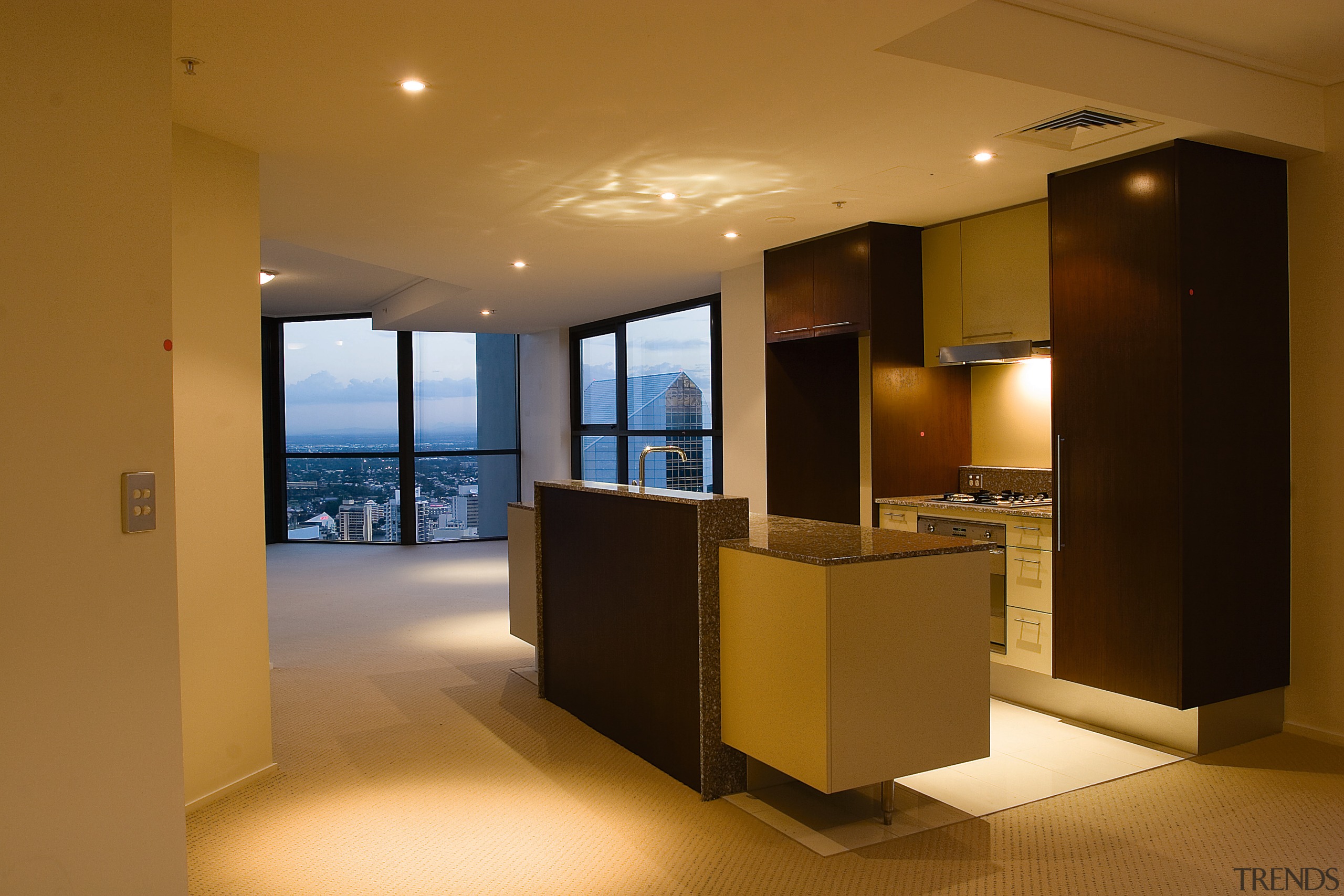Open plan apartment kitchen with city views from apartment, architecture, ceiling, floor, flooring, interior design, lobby, real estate, brown