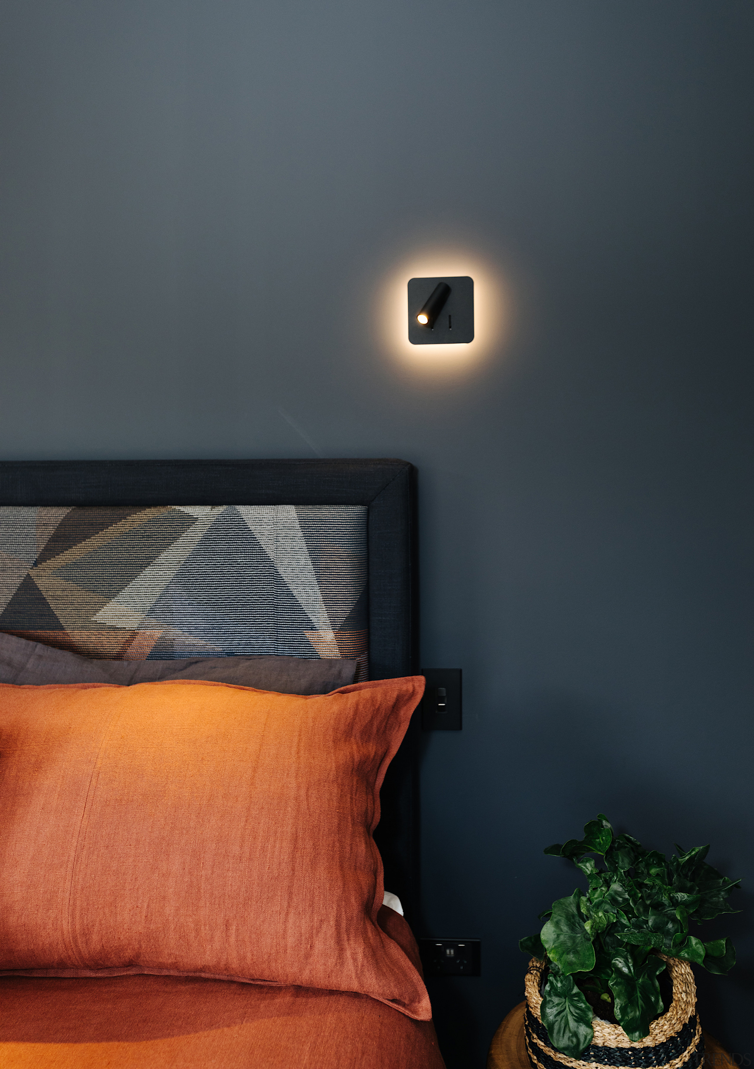 Beautiful, minimalist and back-lit bedside lighting catches the 