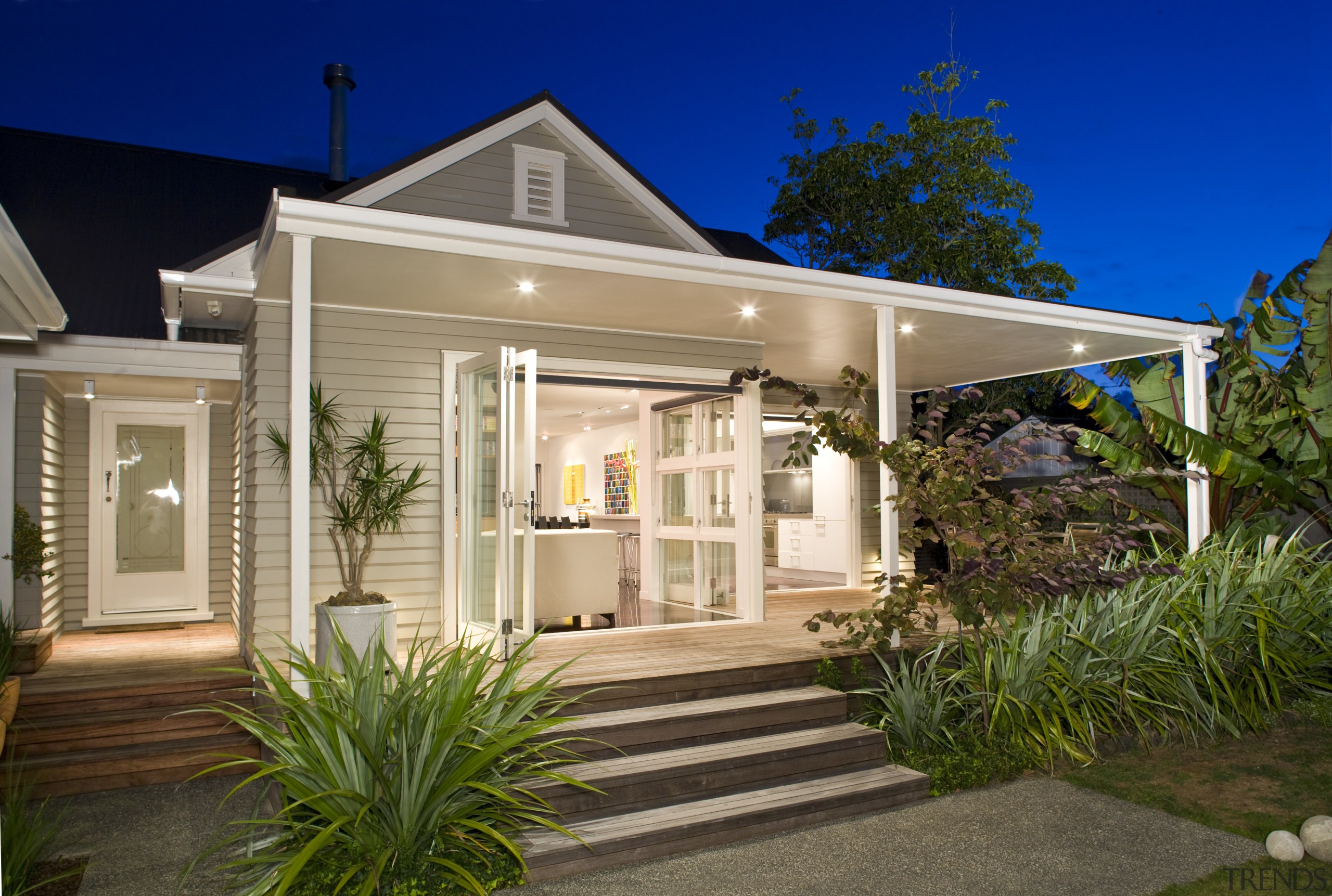 The front and rear of the house have backyard, cottage, estate, facade, home, house, lighting, property, real estate, residential area, siding, brown