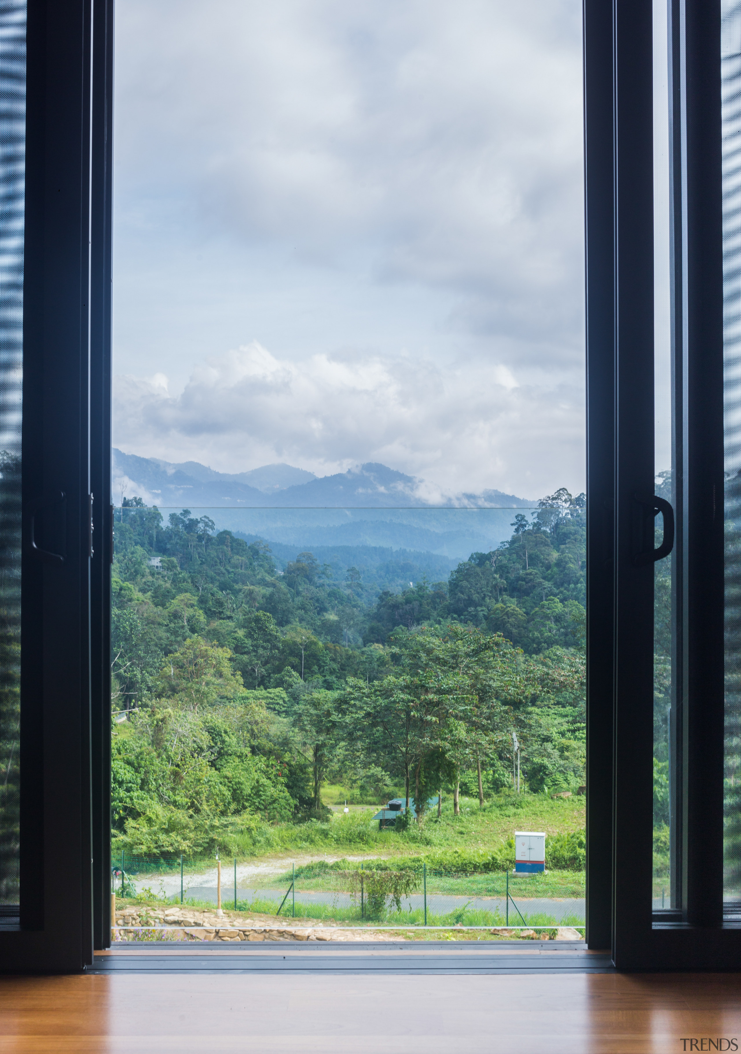 Looking out from an upstairs bedroom. - Organic architecture, door, forest, glass, house, mountain, room, sky, tree, window, white, black