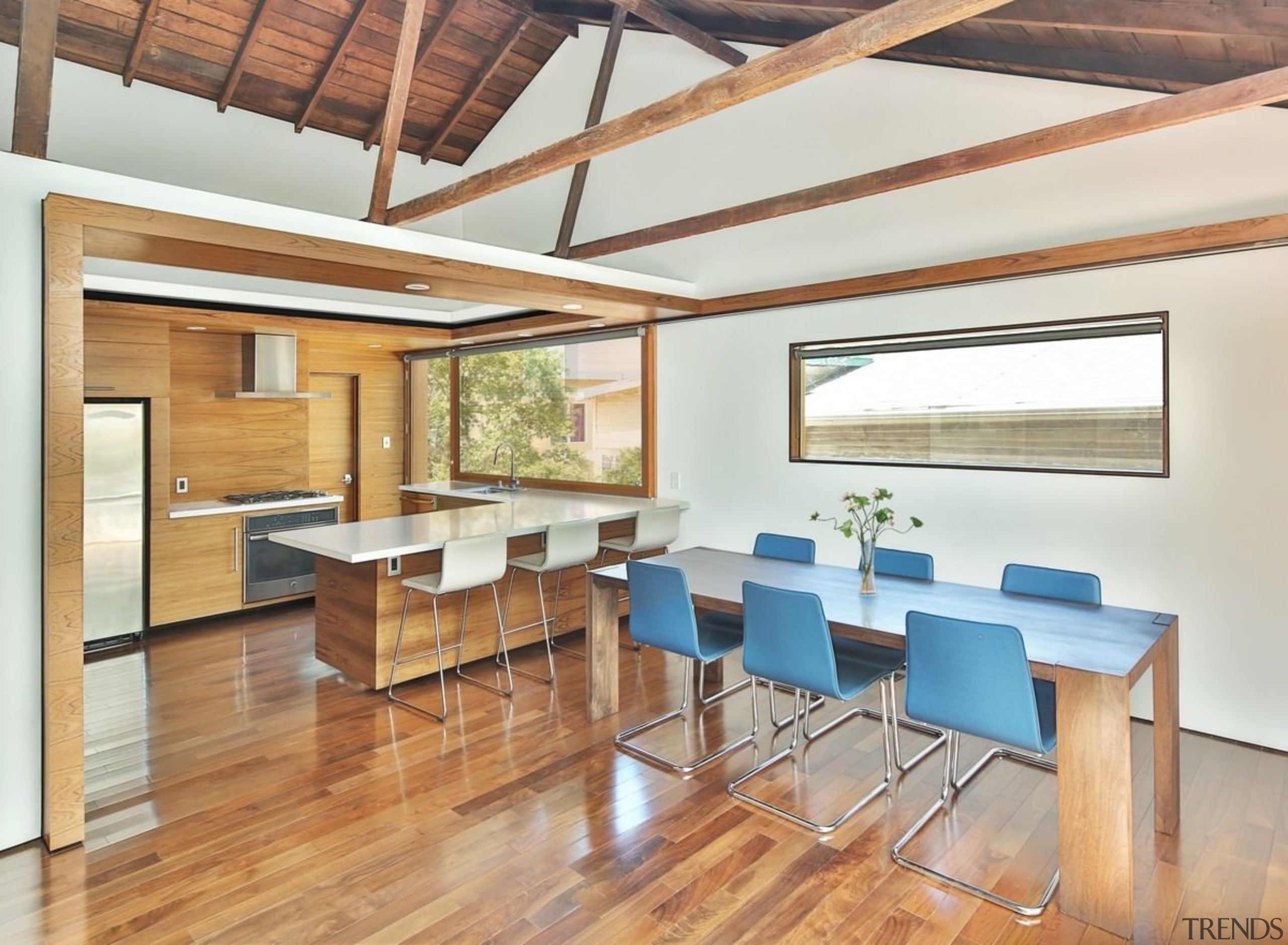 An exposed ceiling with gables opens up the architecture, beam, ceiling, daylighting, dining room, floor, flooring, hardwood, house, interior design, loft, real estate, table, wood, wood flooring, white, orange