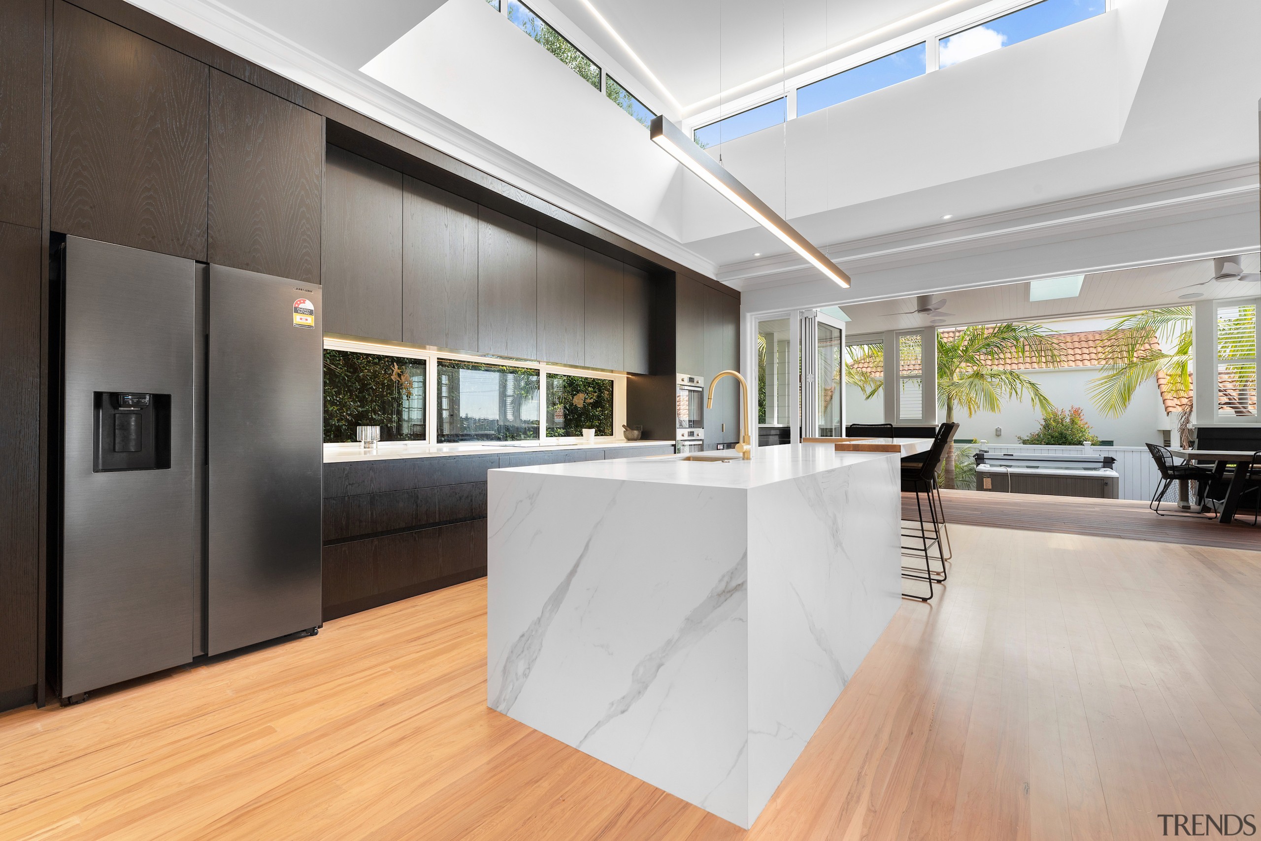 The chunky marble-look island is the kitchen's leading 