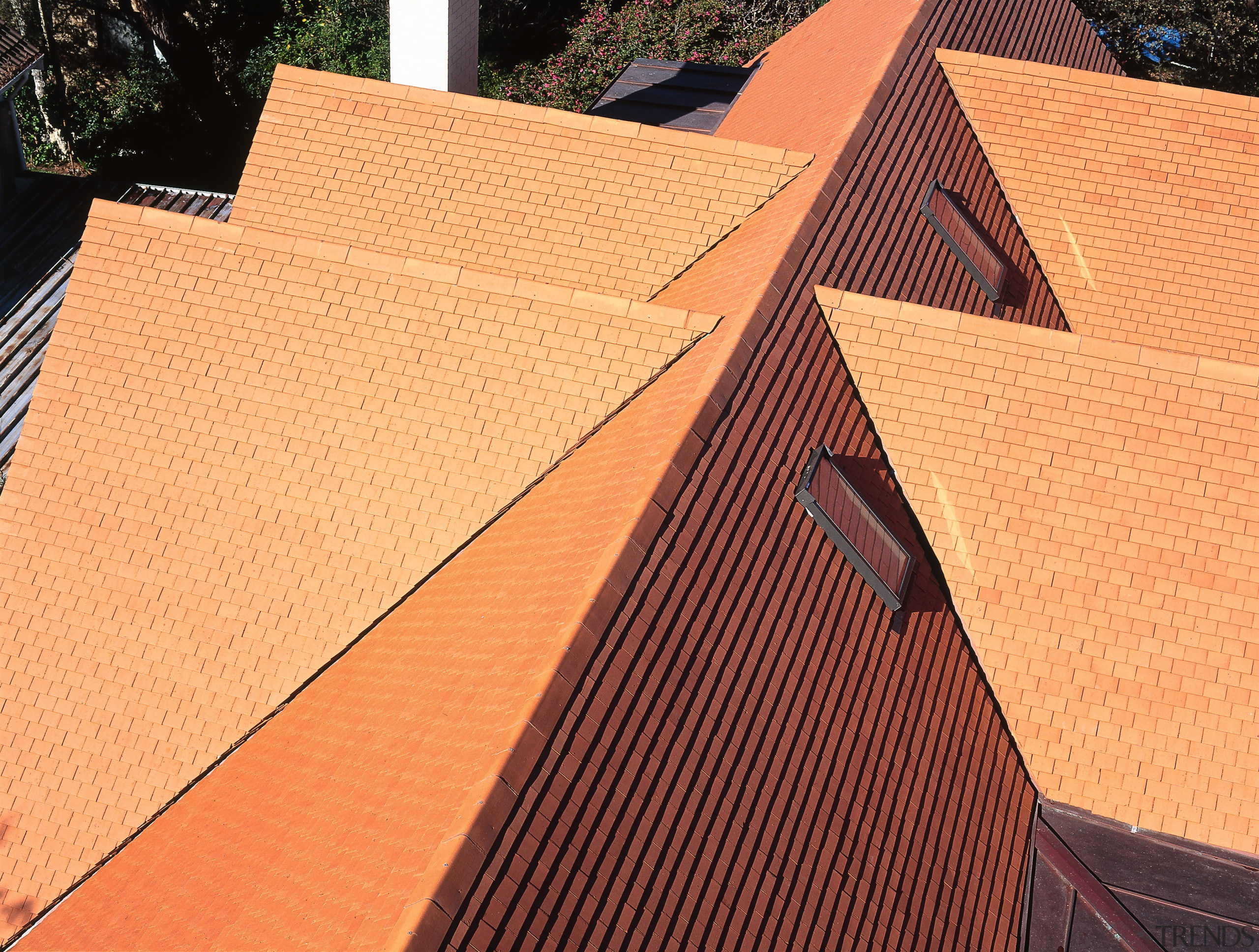 Wunderlich Heritage Shingles in Spanish Red highlight the angle, brick, brickwork, daylighting, facade, line, outdoor structure, roof, wall, wood, wood stain, orange