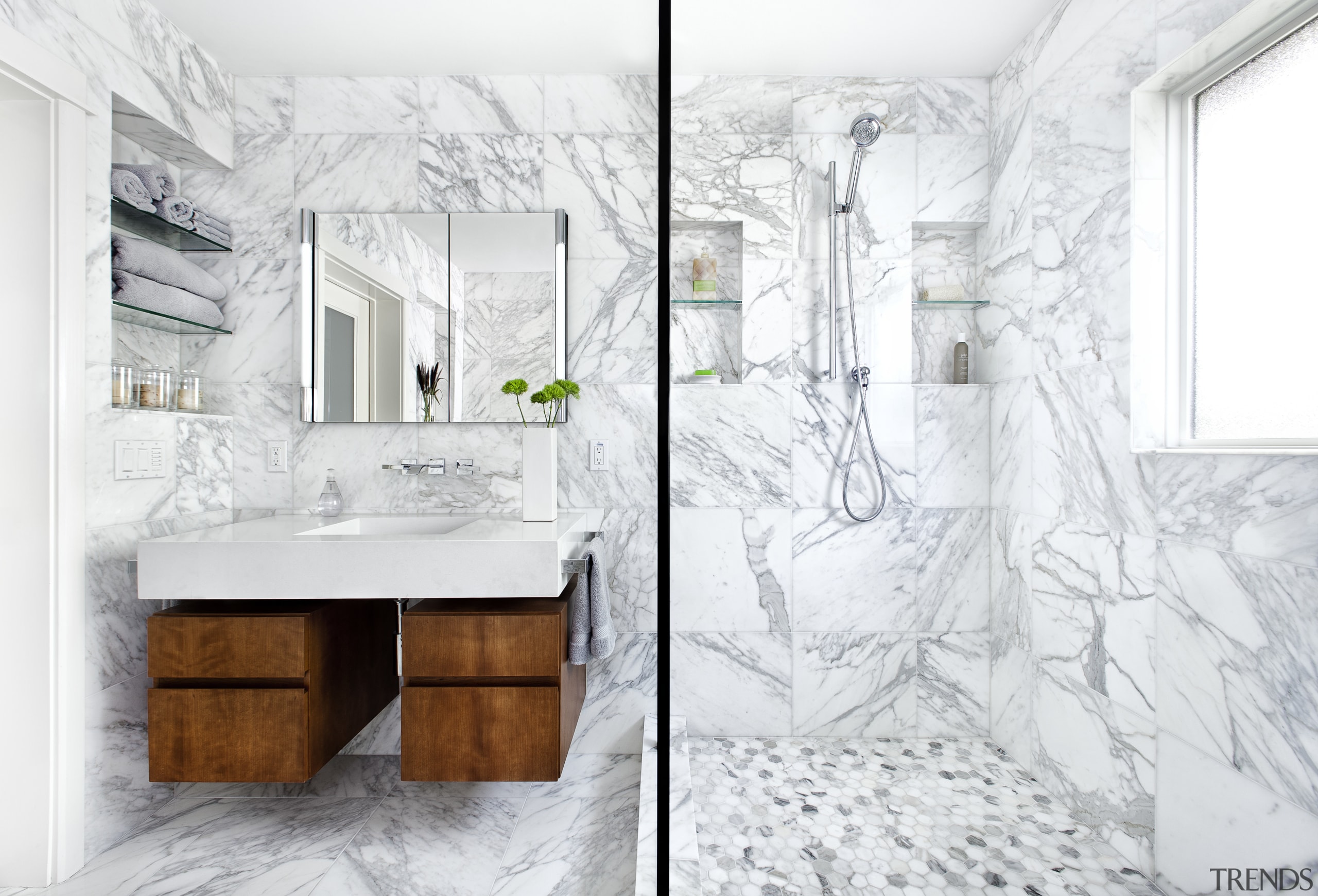 Calacatta Gold marble lines this remodeled bathroom. The bathroom, bathroom accessory, bathroom cabinet, floor, home, interior design, plumbing fixture, product design, room, sink, wall, white