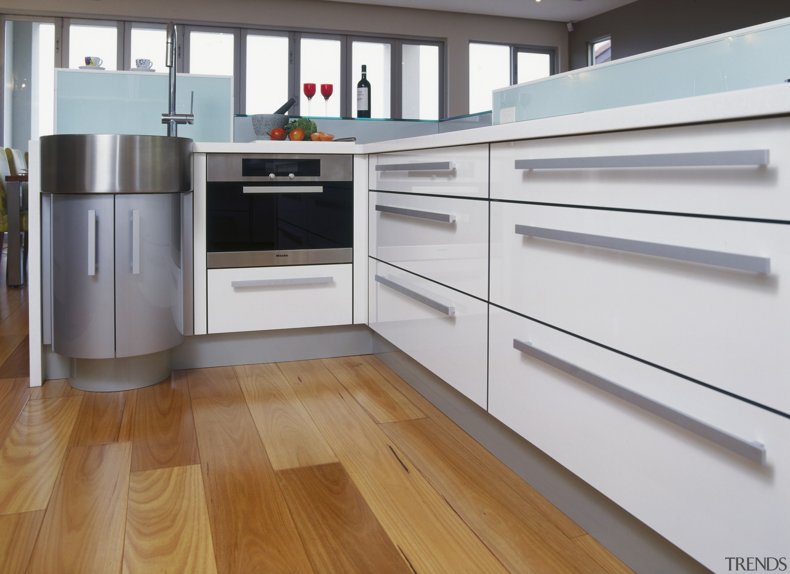 View of kitchen with water dispenser, kitchen appliances. cabinetry, countertop, floor, flooring, hardwood, home appliance, kitchen, laminate flooring, wood, wood flooring, white, gray