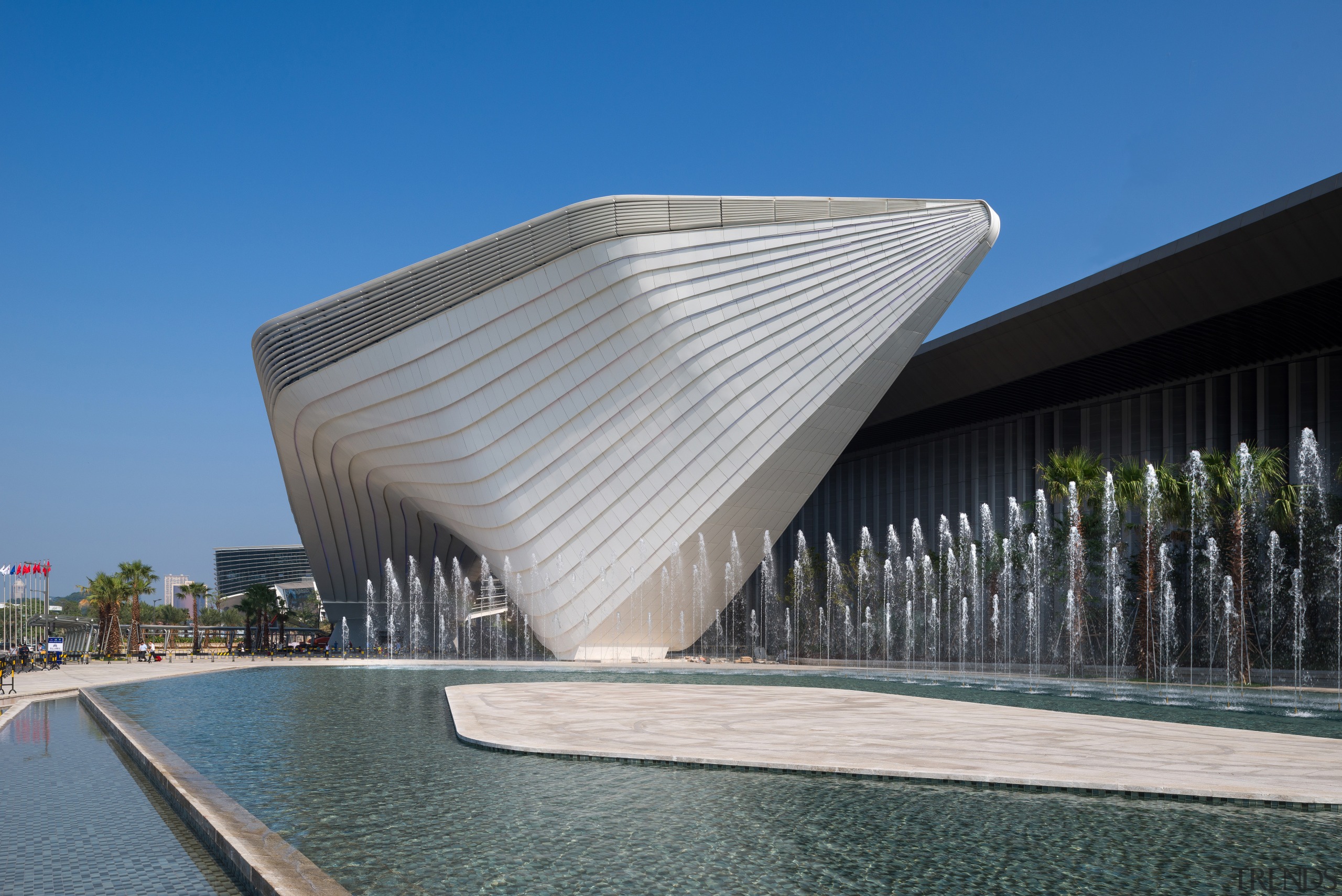 An architectural ribbon winds around the Zhuhai International architecture, building, commercial building, corporate headquarters, daylighting, daytime, facade, fixed link, headquarters, landmark, mixed use, structure, water, gray