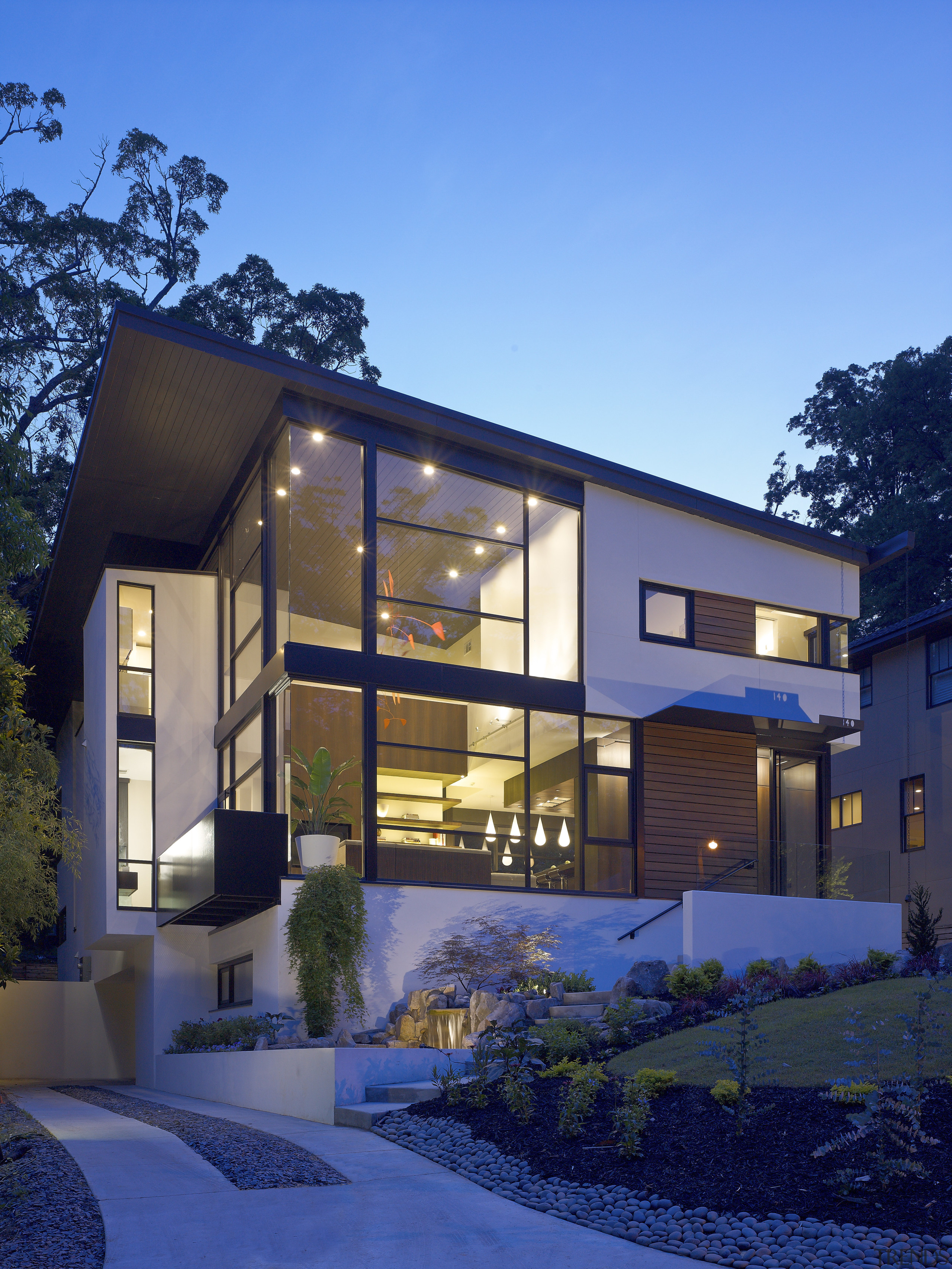 Evening view of the entrance way &amp; the architecture, building, cottage, elevation, estate, facade, home, house, property, real estate, residential area, roof, siding, window, blue