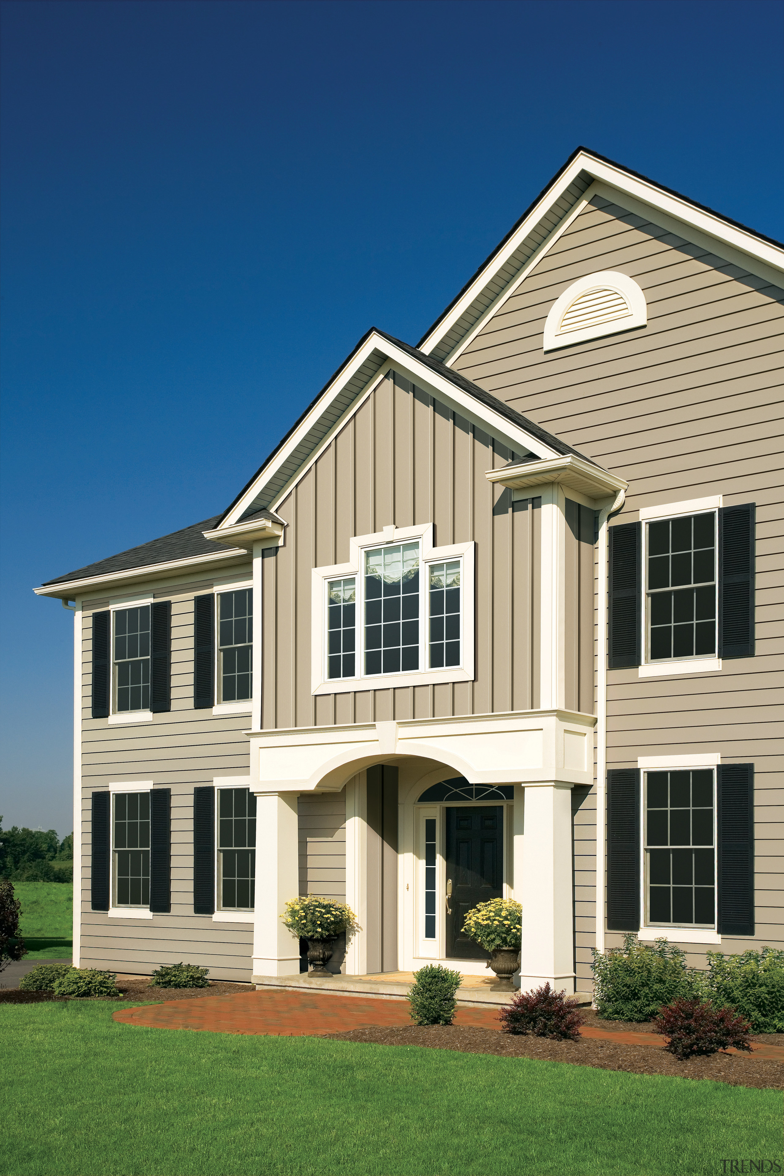 view of this house featuring crane board performance cottage, elevation, estate, facade, farmhouse, home, house, property, real estate, residential area, siding, window, blue, orange