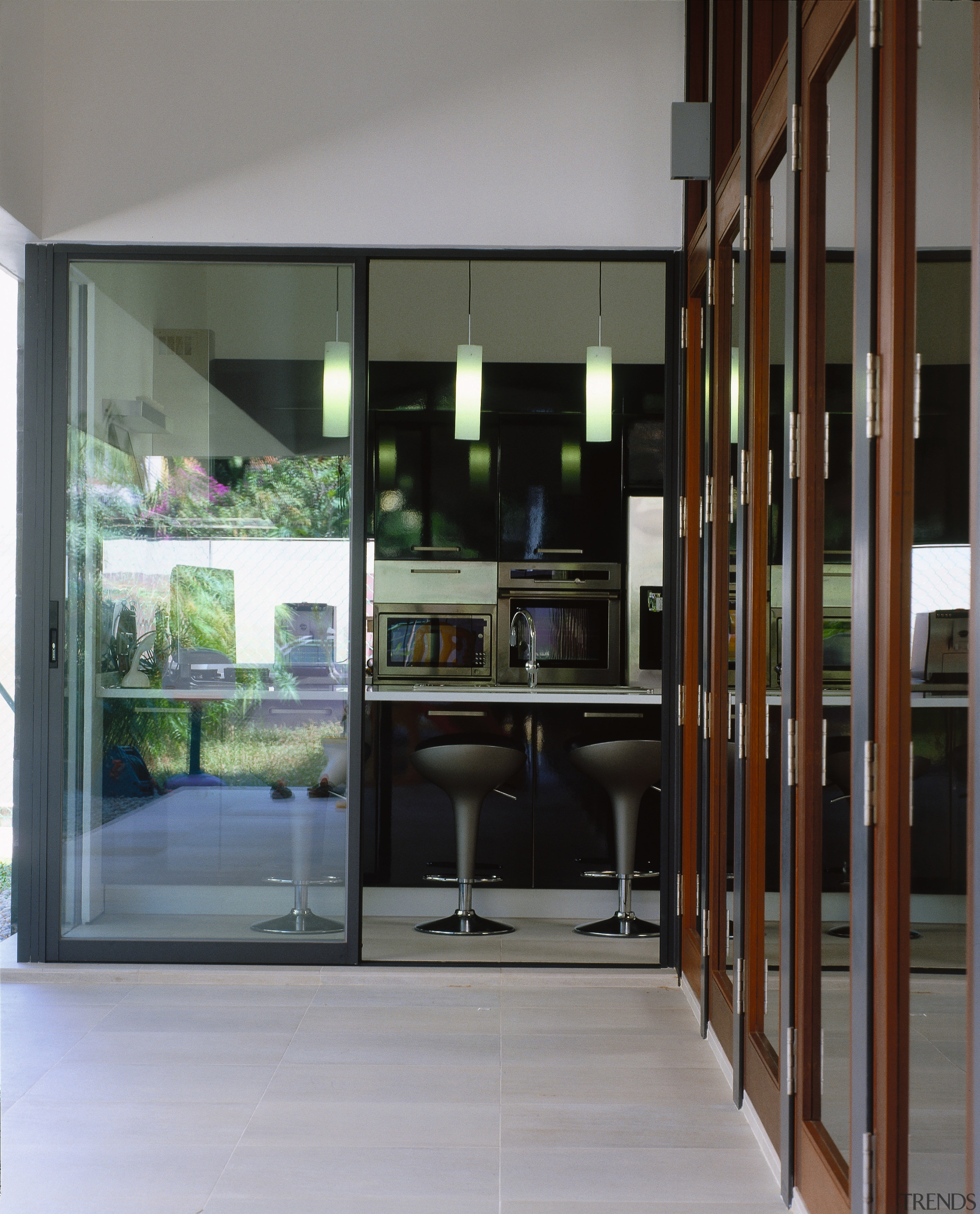 view of the patio leading inside to the architecture, door, furniture, house, interior design, window, gray, black