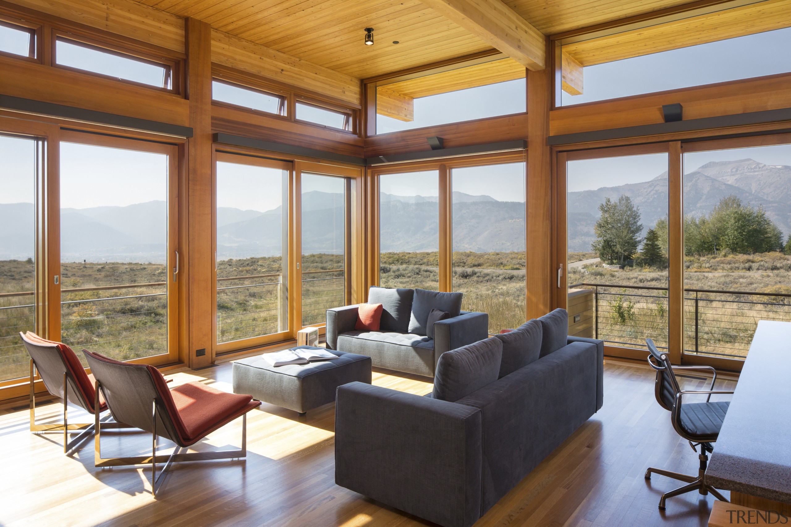 The study-den in this holiday home looks out daylighting, hardwood, home, house, interior design, living room, real estate, roof, window, wood, brown