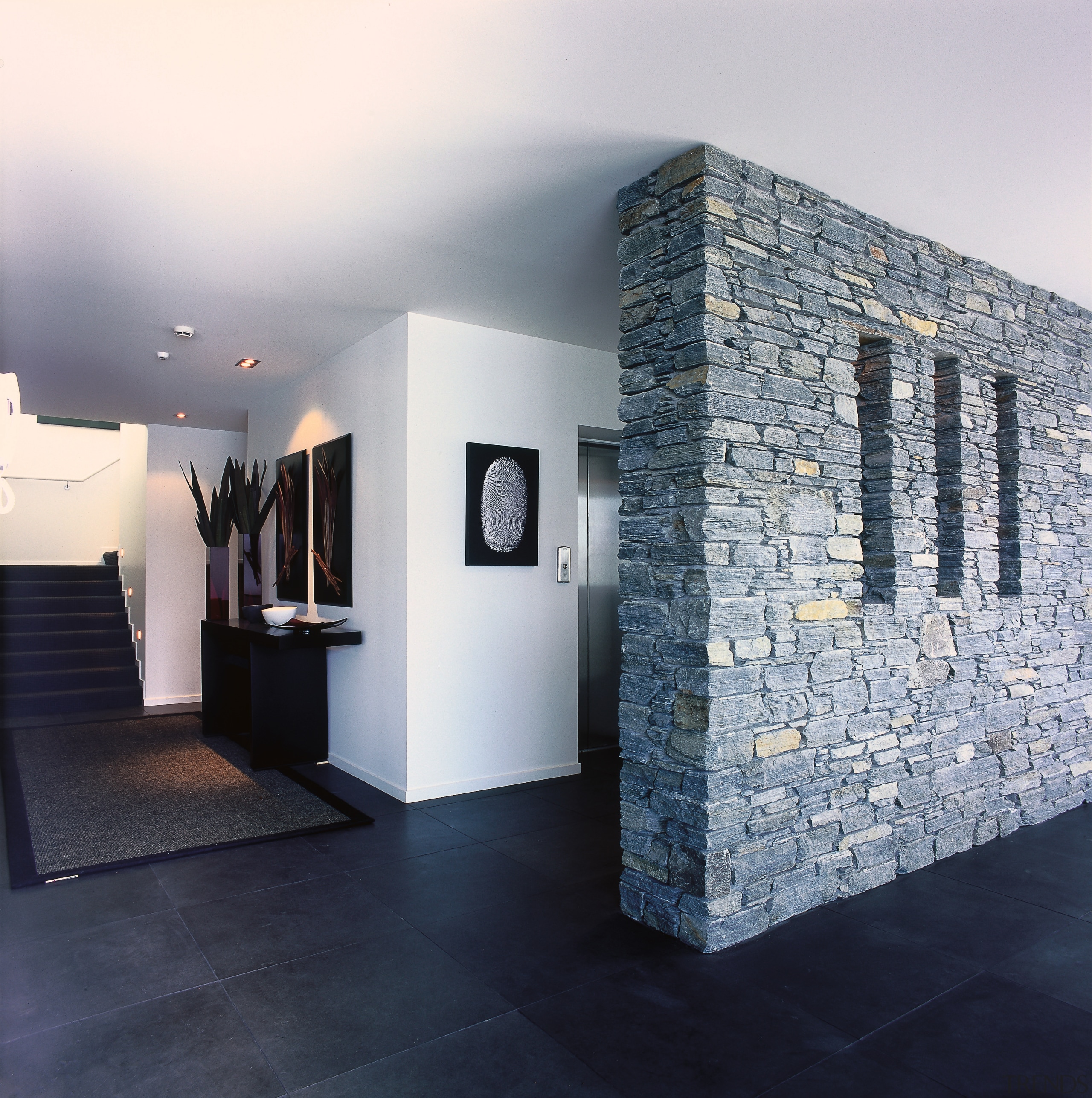 A view of a hallway, black tiles, stone architecture, interior design, wall, gray, black