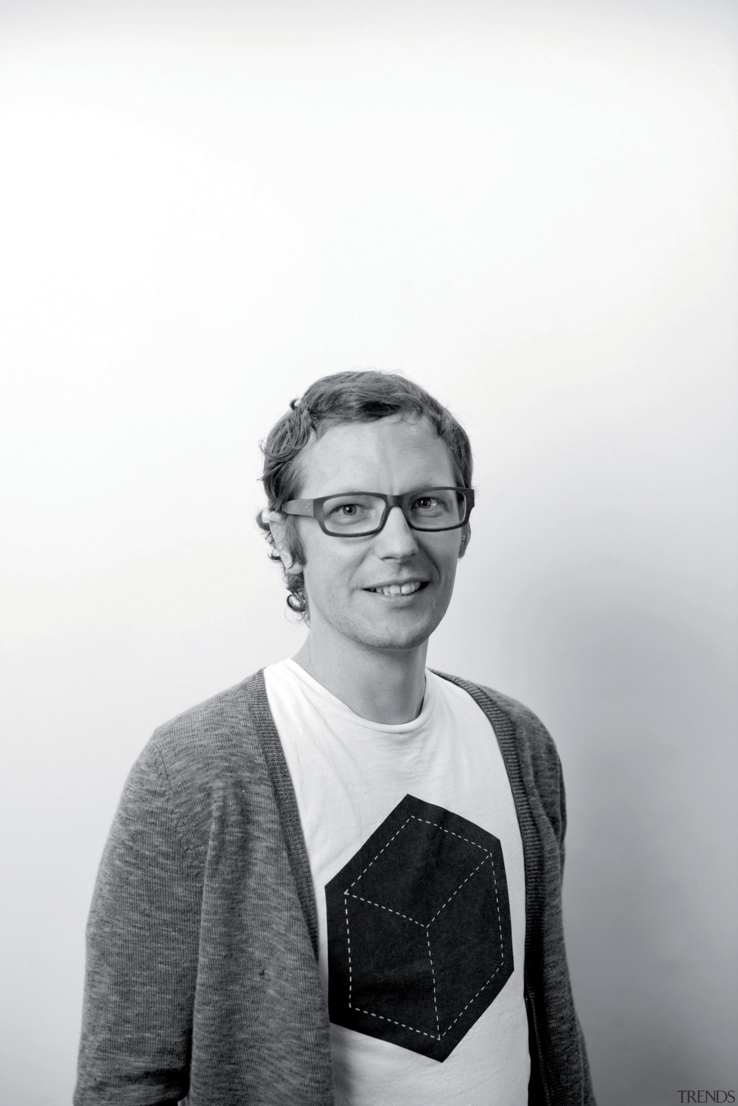 Urban renewal  Jasmax architect Gary Marshall puts black, black and white, eyewear, facial expression, gentleman, glasses, monochrome, monochrome photography, outerwear, person, photograph, photography, portrait, smile, snapshot, standing, vision care, white, white