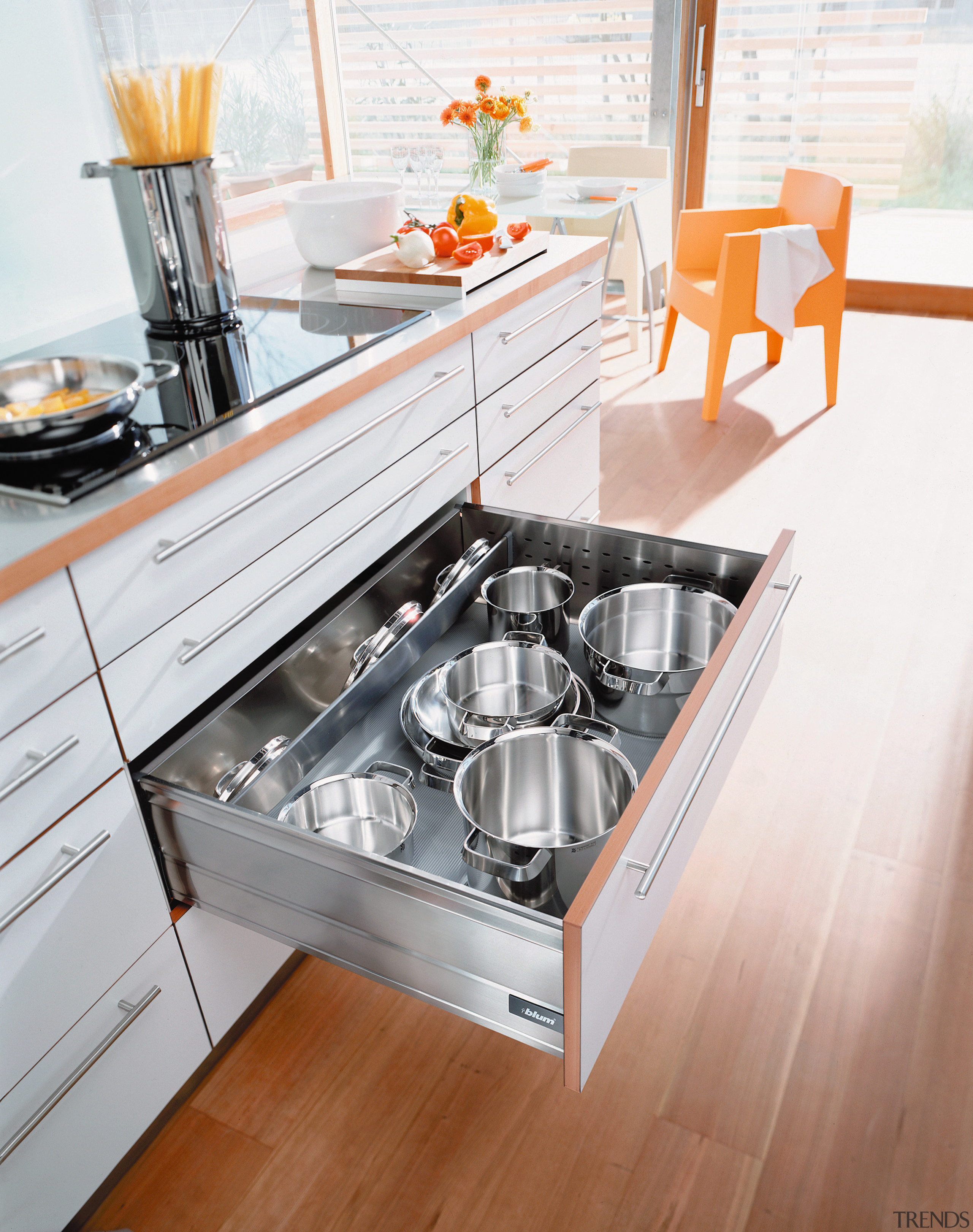 A view of some kitchen cabinetry by Blum countertop, floor, furniture, kitchen, kitchen appliance, kitchen stove, product design, table, white