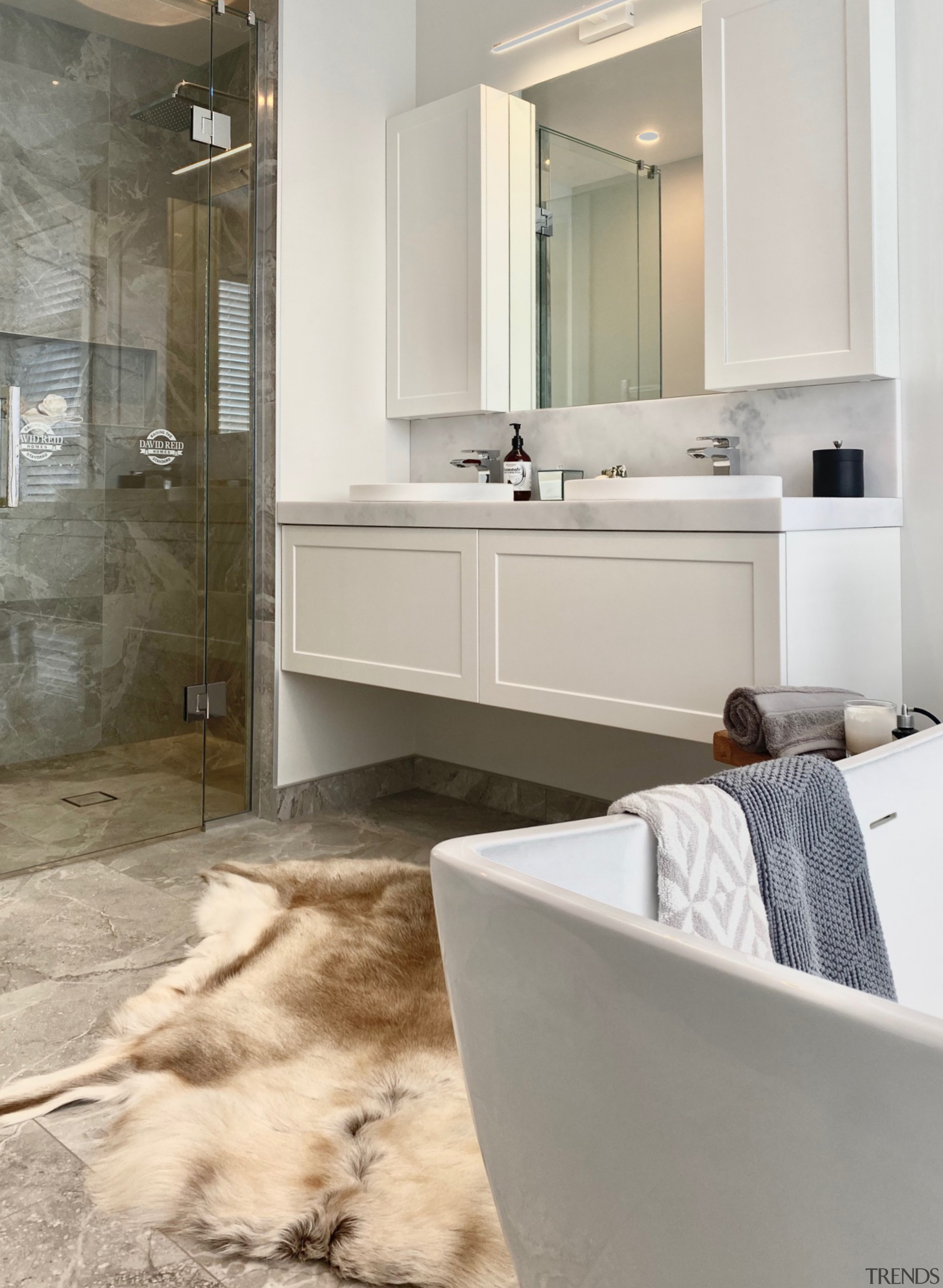 The vanity and wall cabinets have panelled fronts 