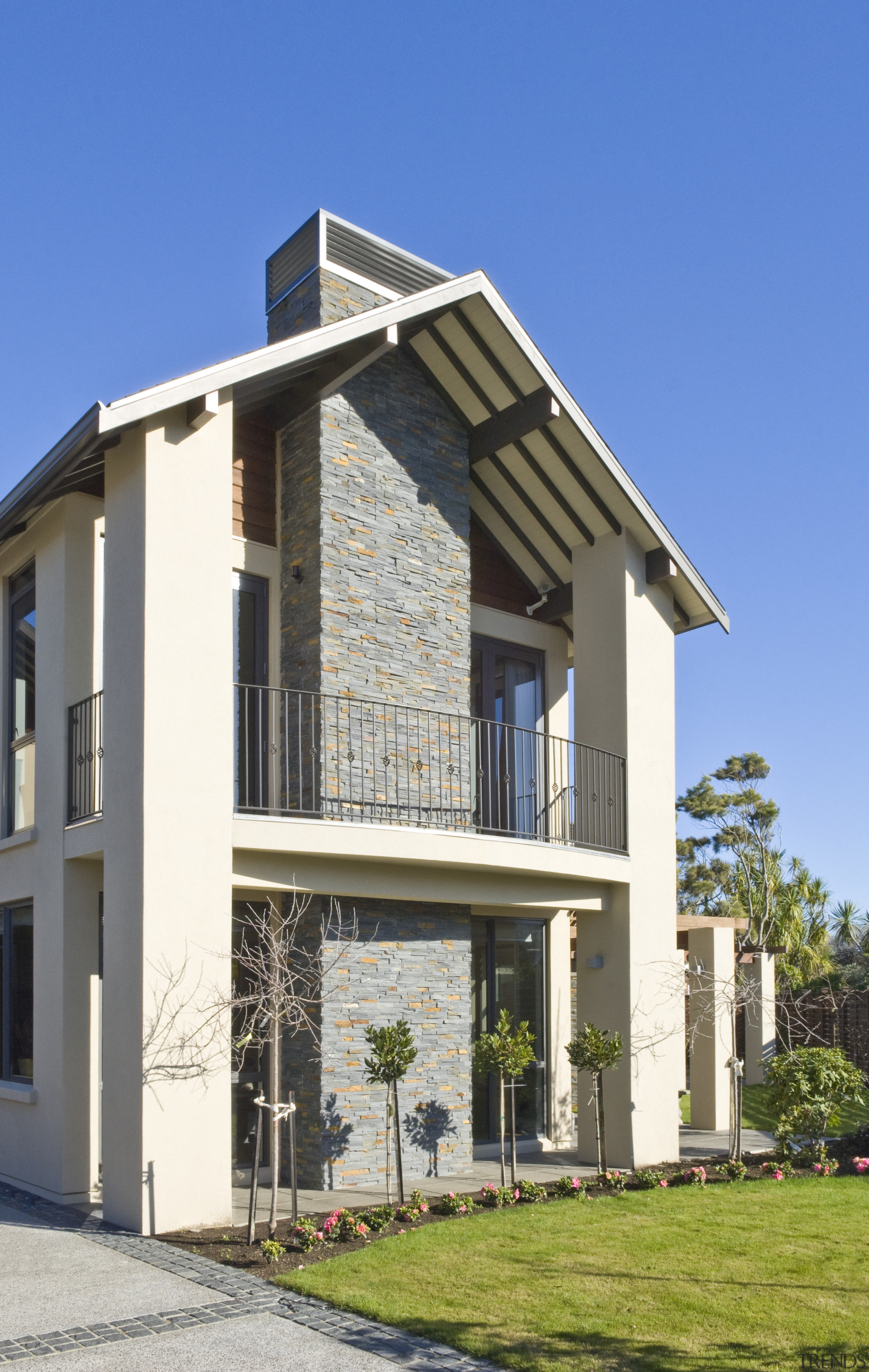 Exterior view of a high-end home with a building, condominium, cottage, elevation, estate, facade, home, house, property, real estate, residential area, villa, teal