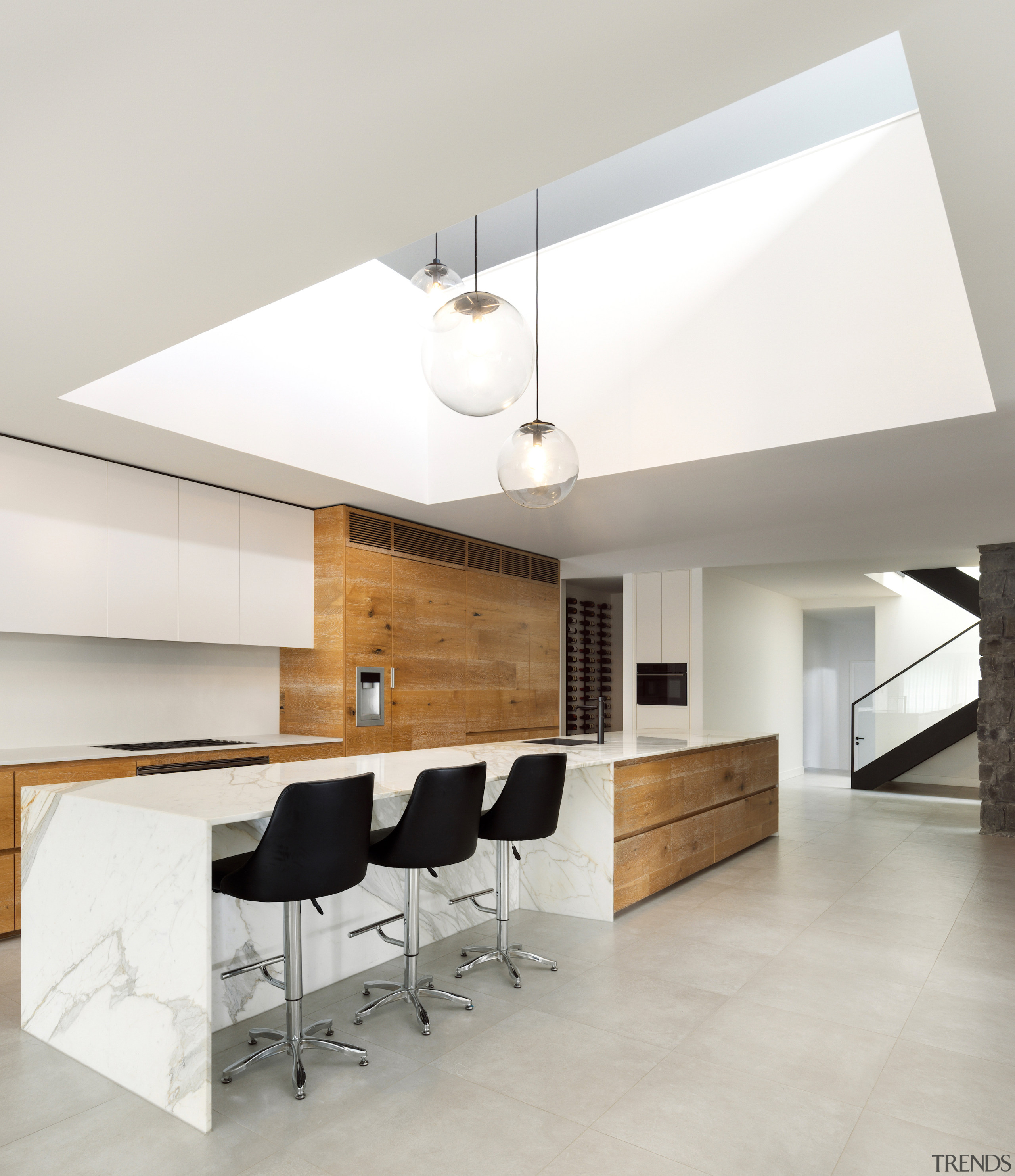 A double-height void above the kitchen floods the 