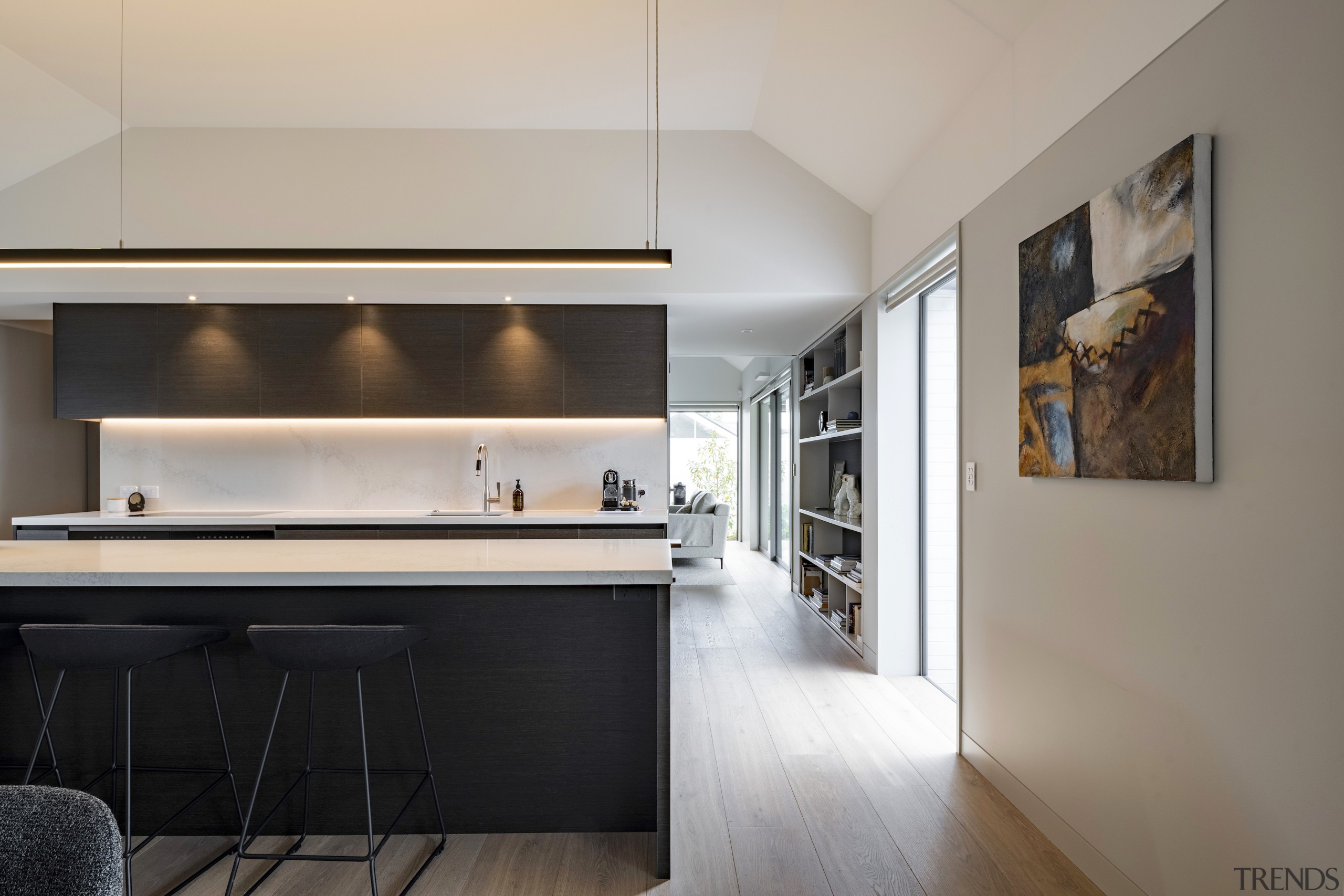 Looking past the central kitchen to the light-filled 