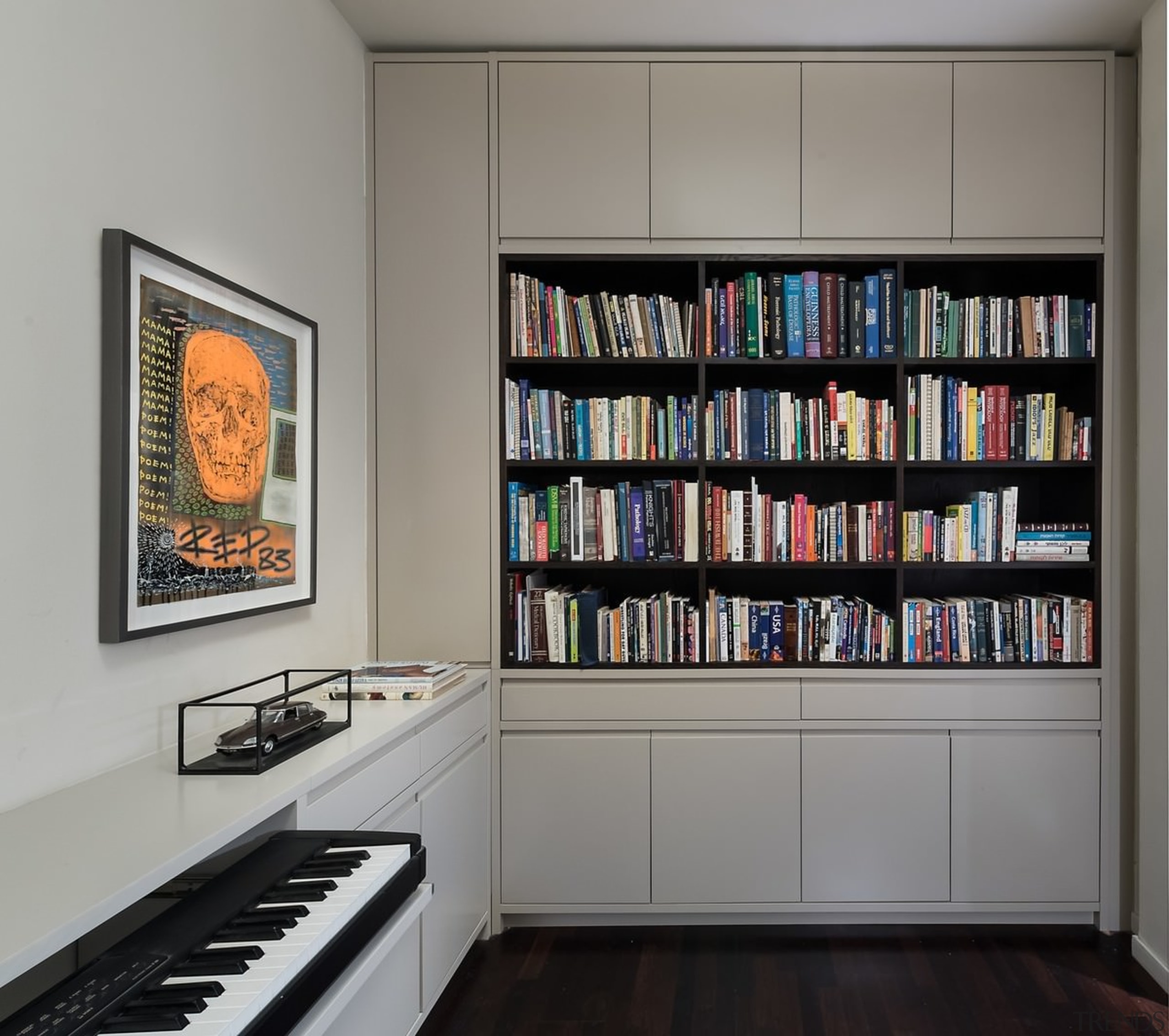 The library and study has a classical feeling bookcase, furniture, shelf, shelving, gray, black