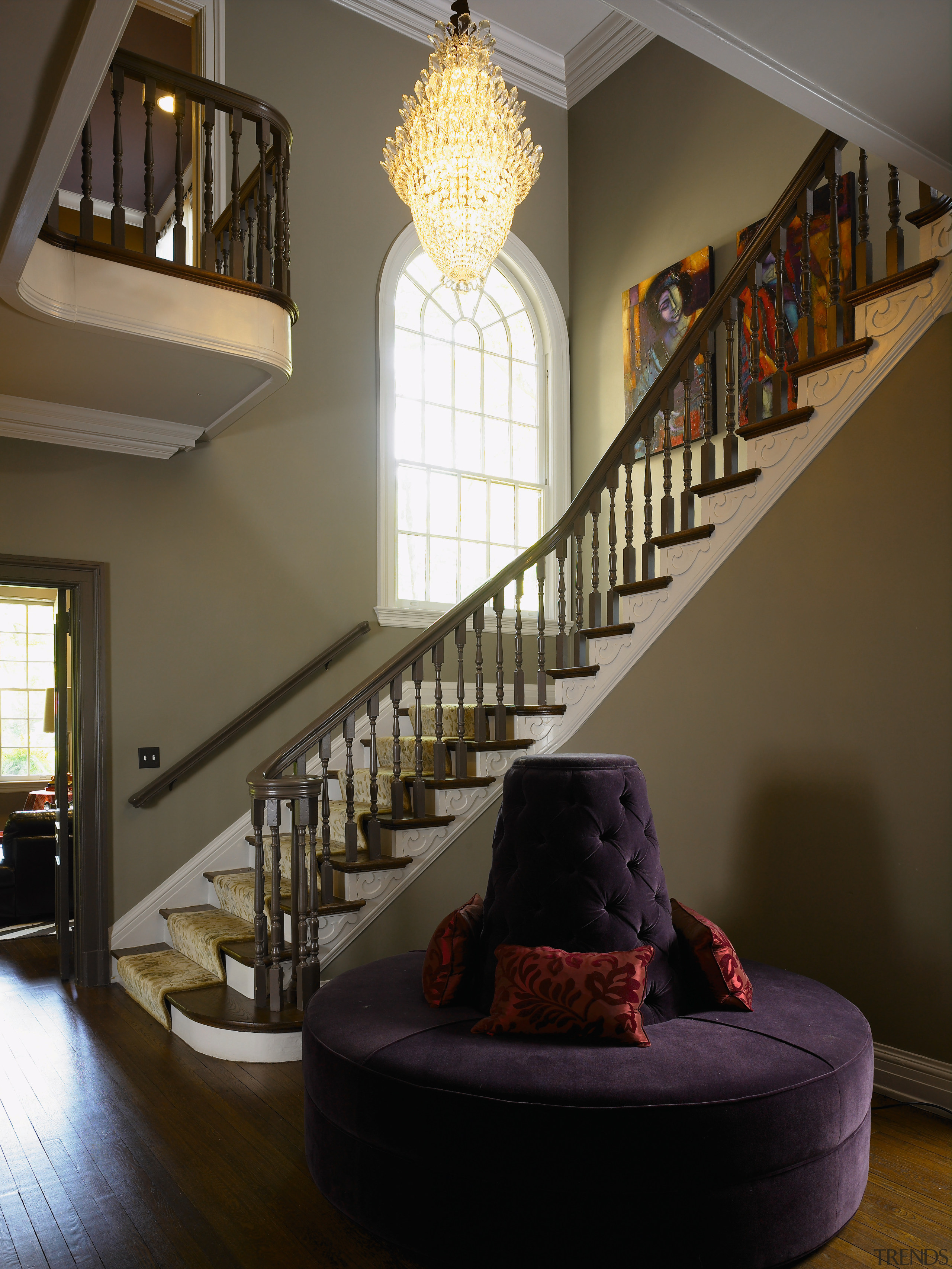 The centrally located stair hall is overlooked by architecture, ceiling, daylighting, estate, handrail, home, interior design, living room, lobby, room, stairs, wall, window, brown