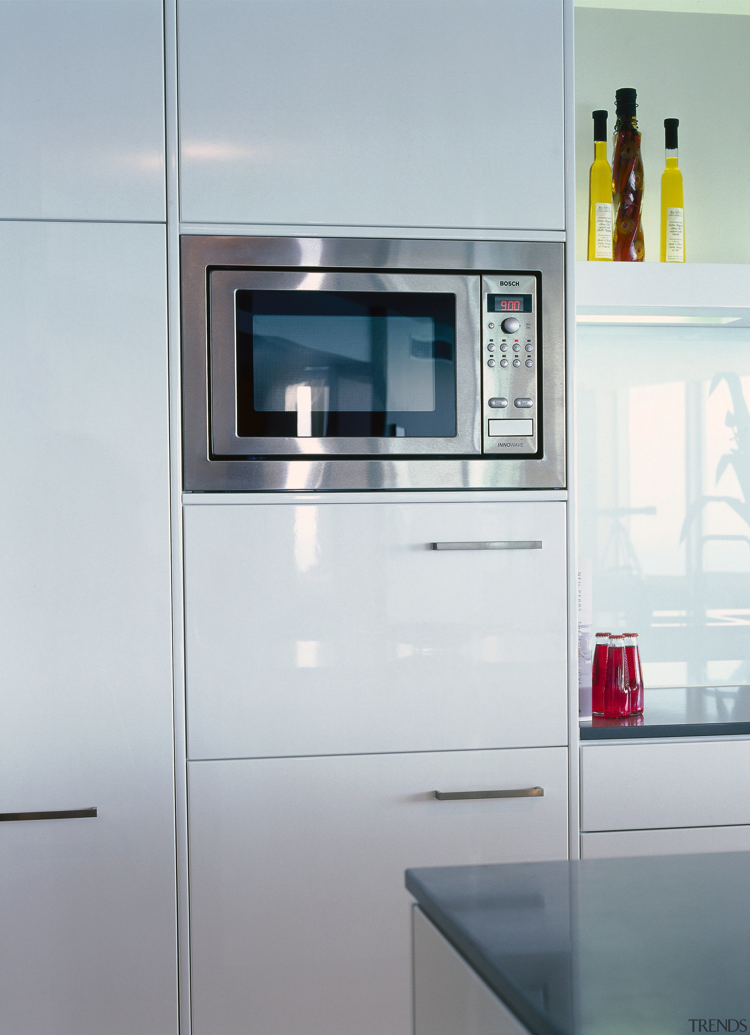 Kitchen with cream cabinetry and stainless steel microwave home appliance, kitchen, kitchen appliance, kitchen stove, major appliance, product, product design, refrigerator, gray