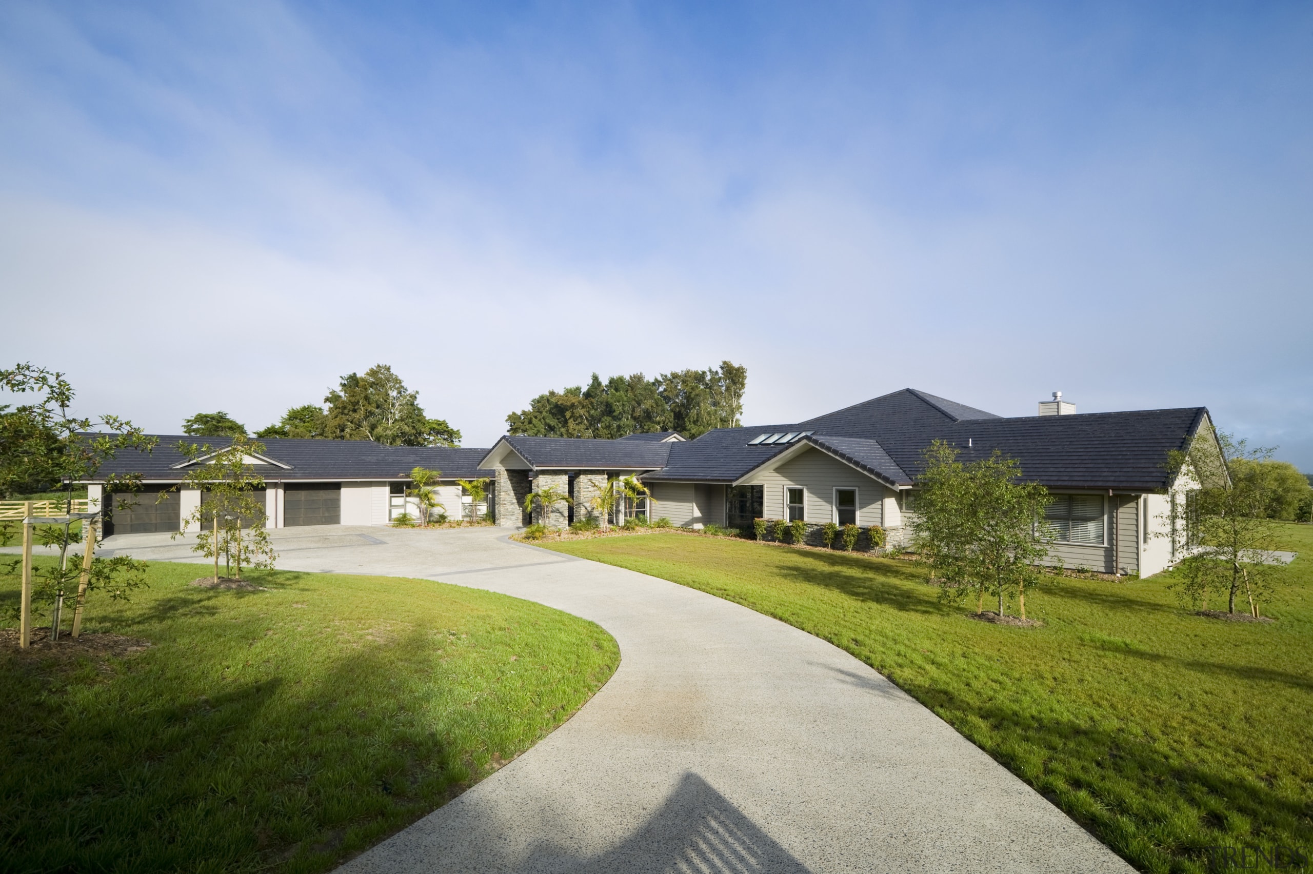 Image of this family home which creates a cloud, cottage, estate, facade, farm, farmhouse, grass, home, house, land lot, landscape, lawn, property, real estate, residential area, sky, suburb, tree, villa, teal