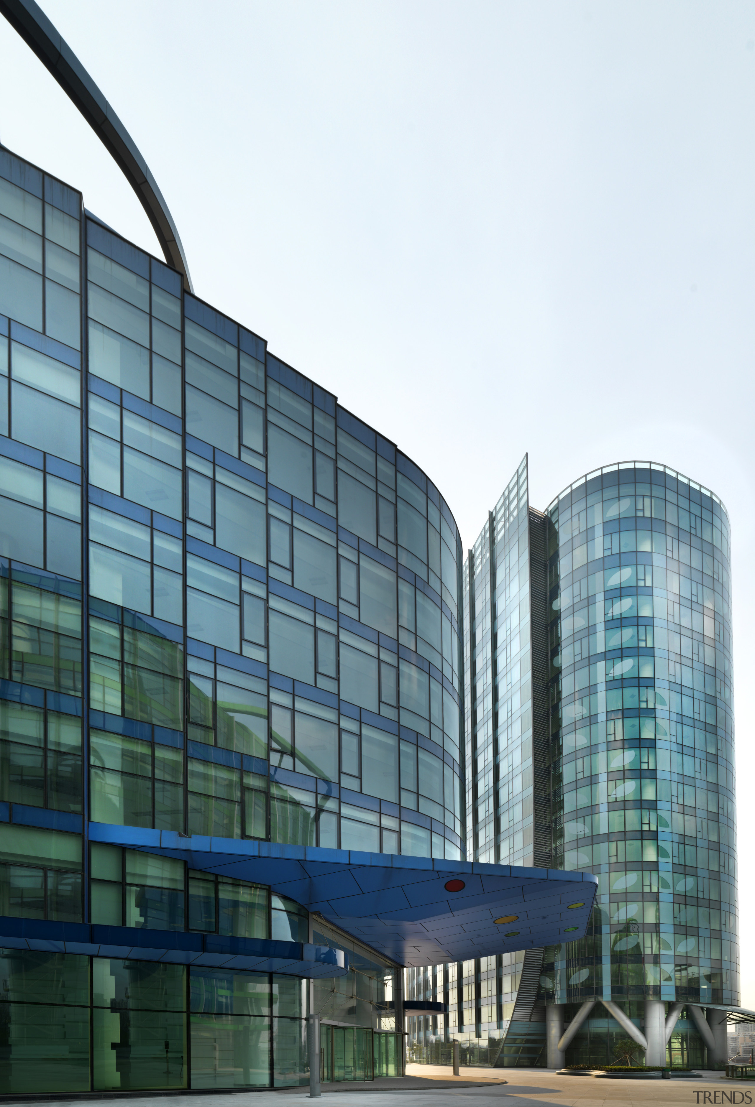 View of the Shanghai International Cruise Terminal. architecture, building, city, commercial building, condominium, corporate headquarters, daytime, facade, headquarters, metropolis, metropolitan area, mixed use, reflection, sky, skyscraper, tower block, teal, white