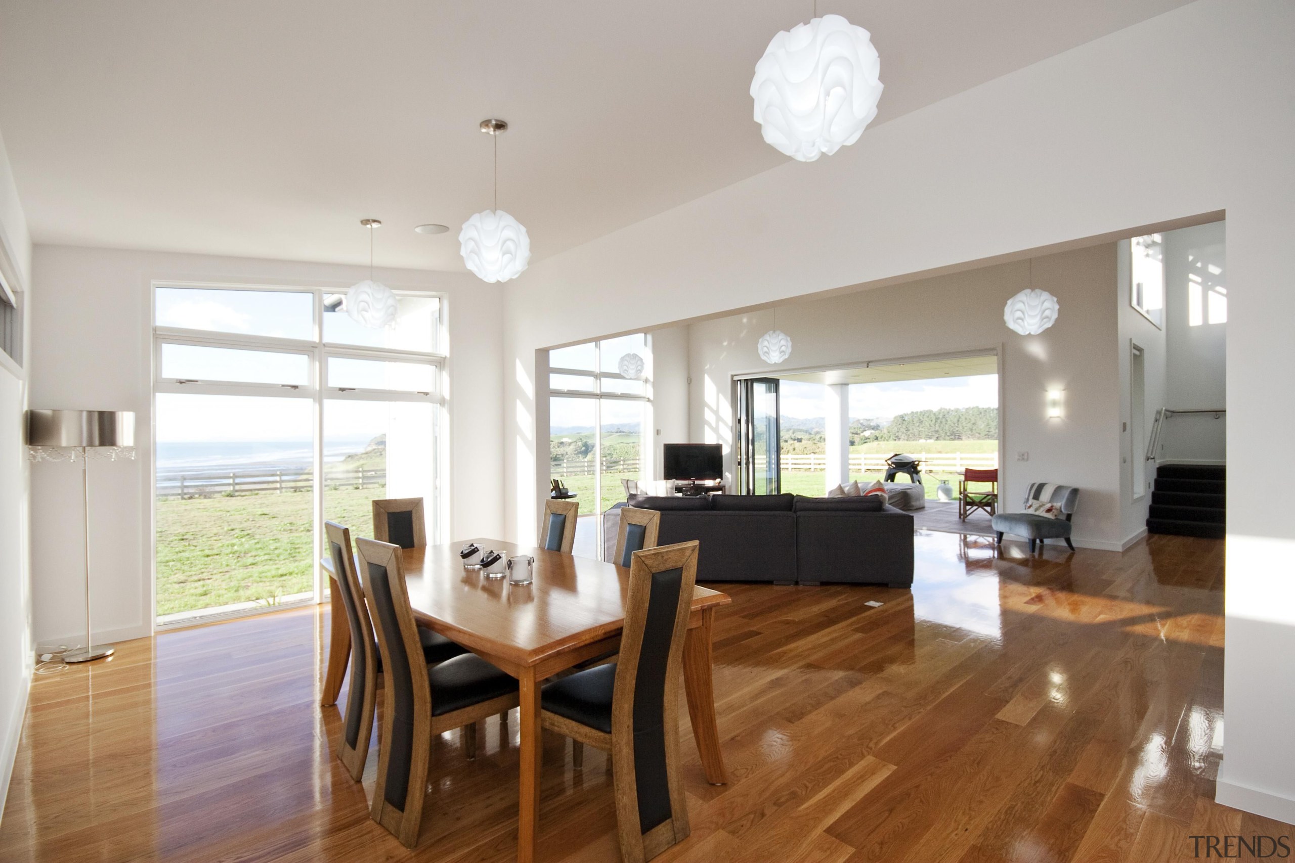 Open plan living with lustrous rich timber flooring ceiling, dining room, floor, flooring, hardwood, home, house, interior design, living room, property, real estate, room, table, window, wood flooring, gray