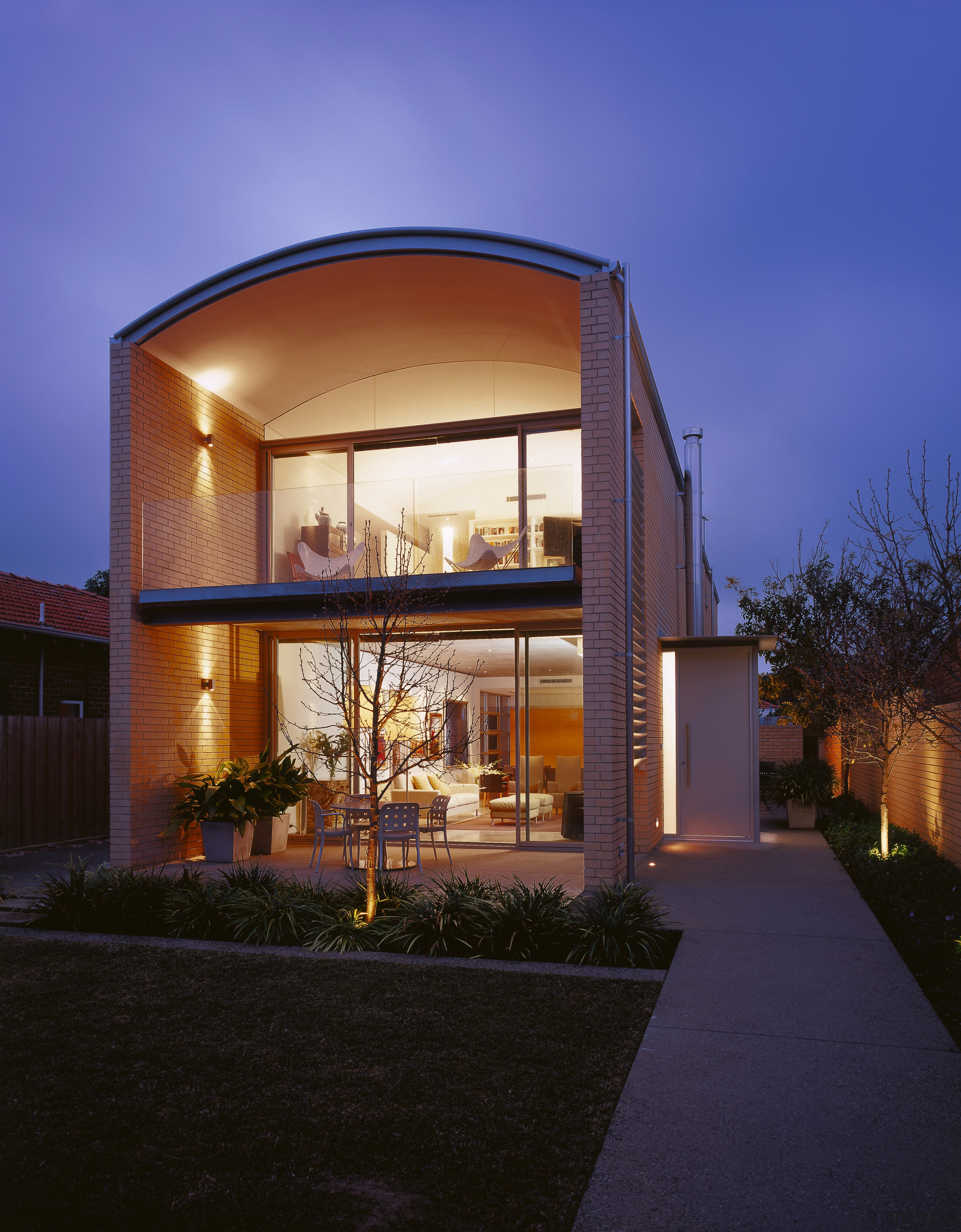 An exterior view of the patio area. - architecture, building, elevation, estate, facade, home, house, lighting, property, real estate, residential area, sky, window, blue, black