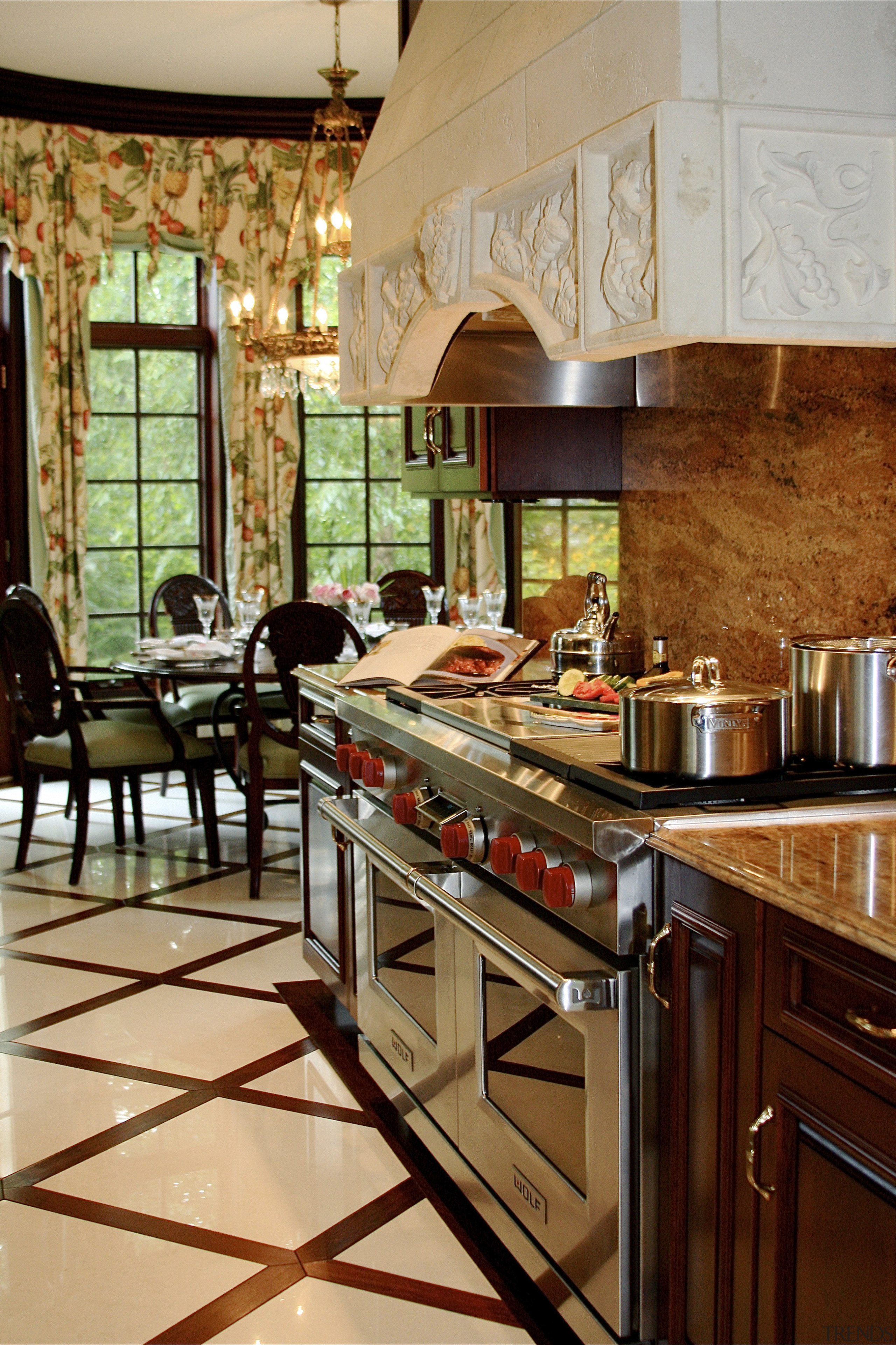 A large Wolf range with a faux stone countertop, flooring, interior design, kitchen, room, brown