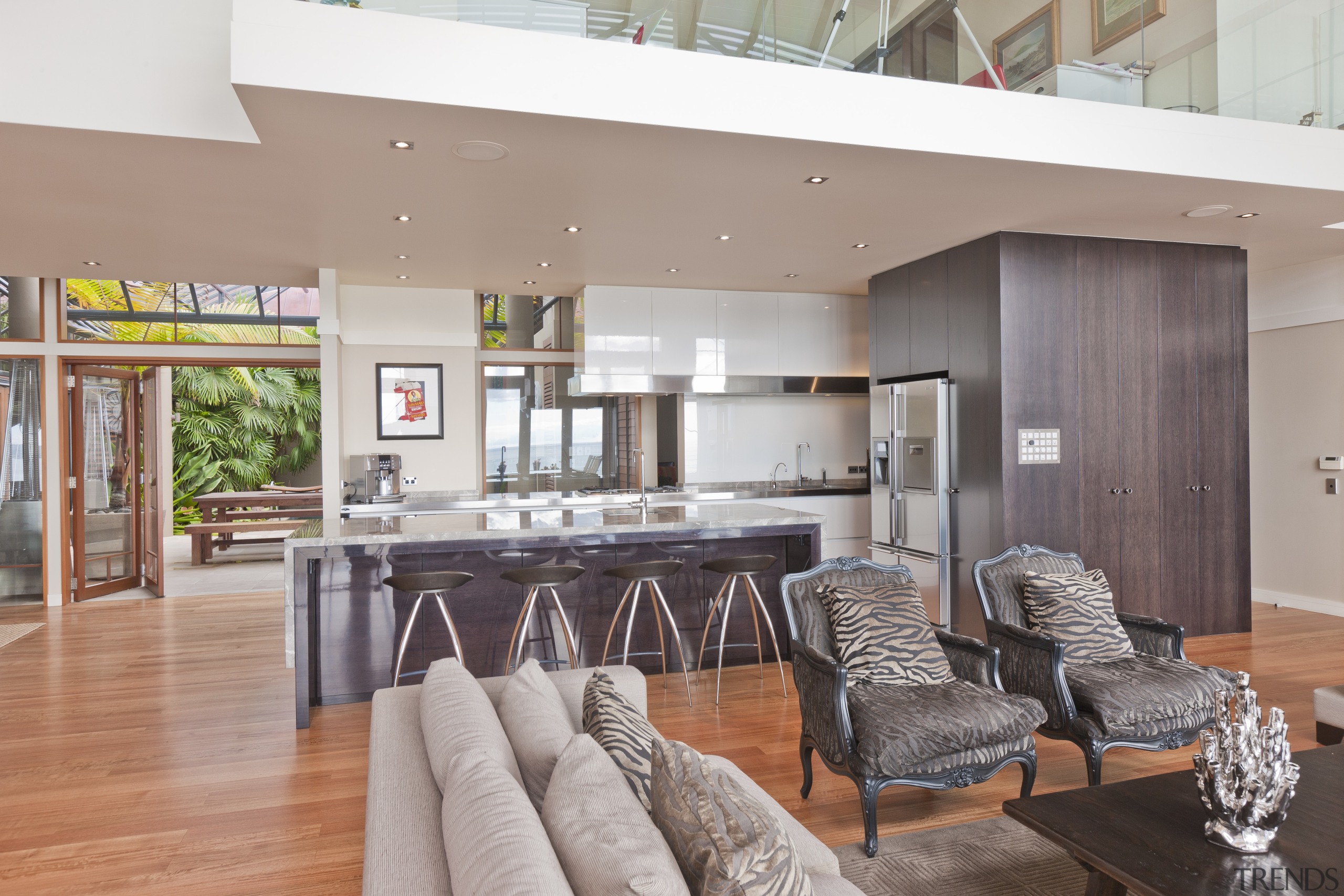 View of open-plan kitchen featuring an island with house, interior design, living room, real estate, table, gray