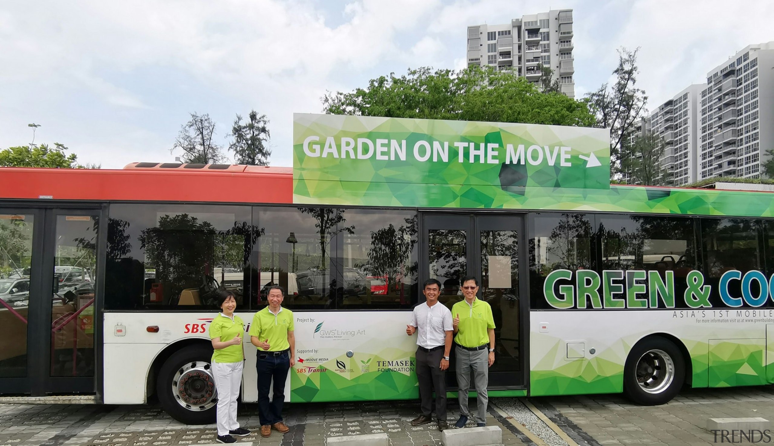 The Singapore green-roofed 10-bus initiative  is called "Gardens advertising, architecture, bus, car, commercial vehicle, mode of transport, motor vehicle, tour bus service, tourism, transport, tree, vehicle, gray, black, white