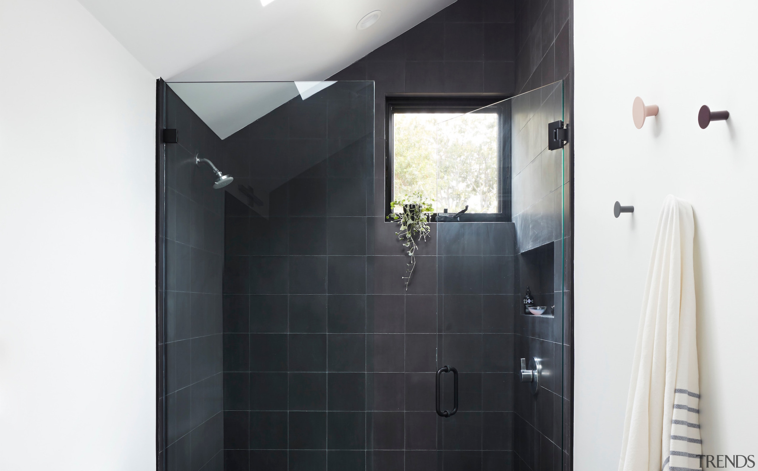 The primary bathroom showcases floor-to-ceiling tiles and a 