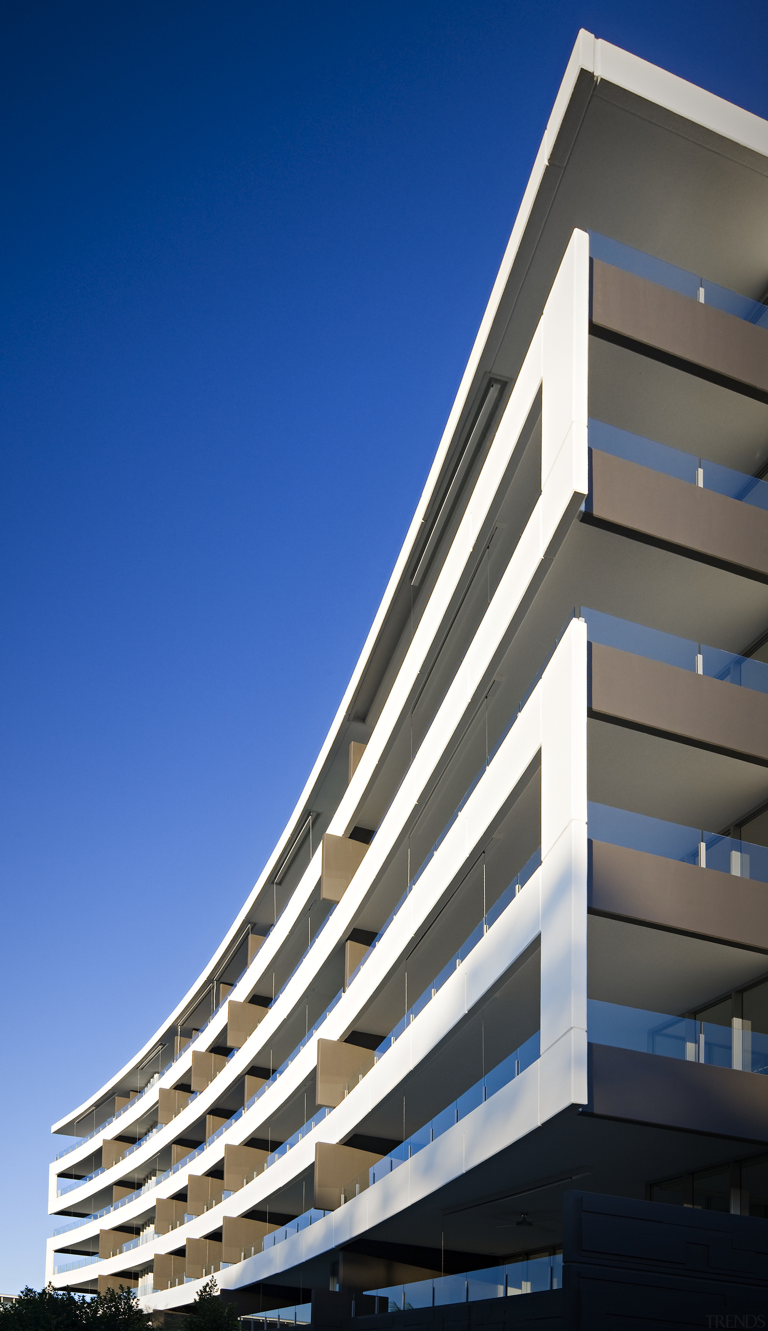 Exterior view of the Flow Apartments which sit apartment, architecture, building, commercial building, condominium, corporate headquarters, daylighting, daytime, facade, headquarters, line, metropolitan area, mixed use, sky, tower block, blue