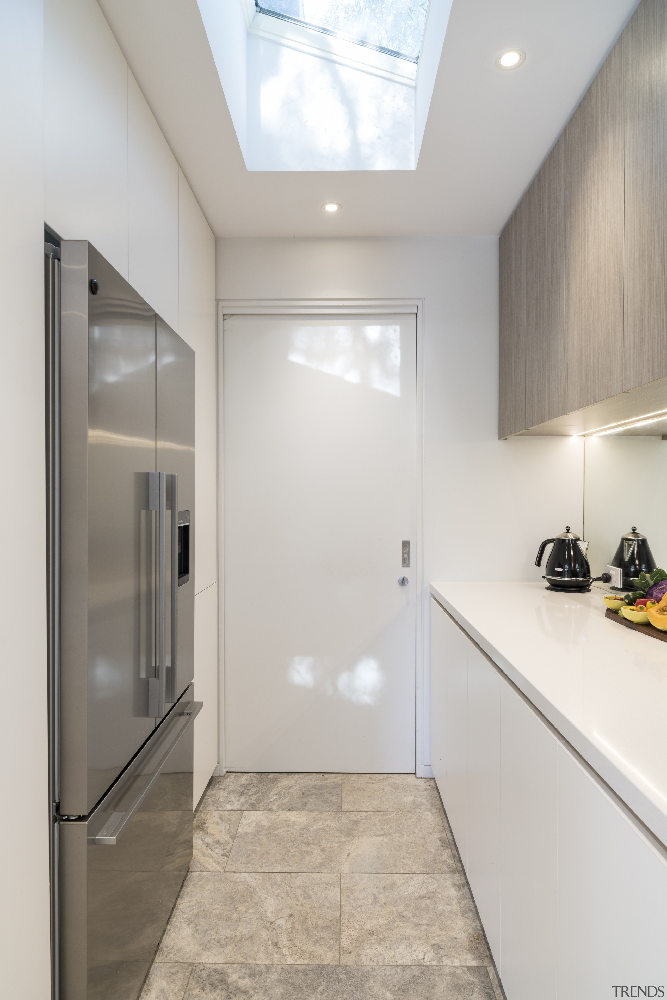 Travertine tile floors seen in this pantry extend ceiling, daylighting, floor, flooring, home, interior design, real estate, room, tile, gray