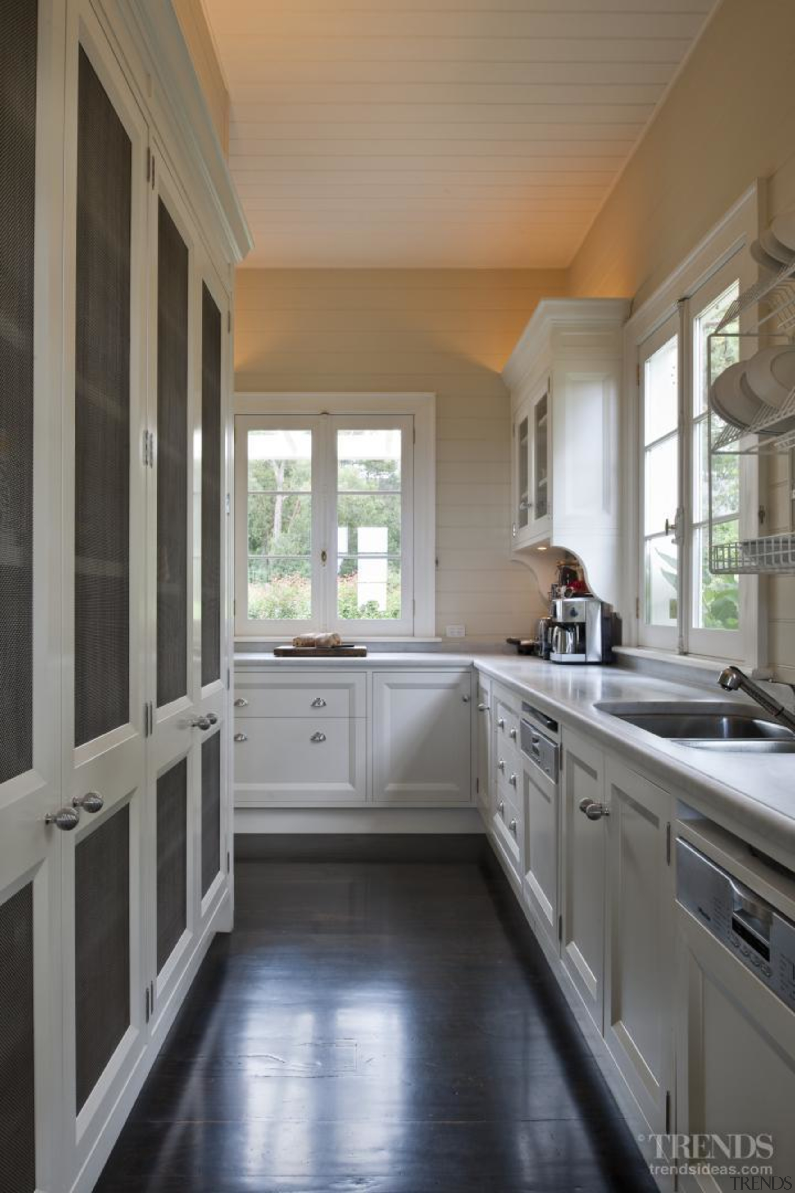 A scullery is tucked behind the cooking centre. cabinetry, countertop, cuisine classique, daylighting, floor, flooring, home, interior design, kitchen, property, real estate, room, window, gray