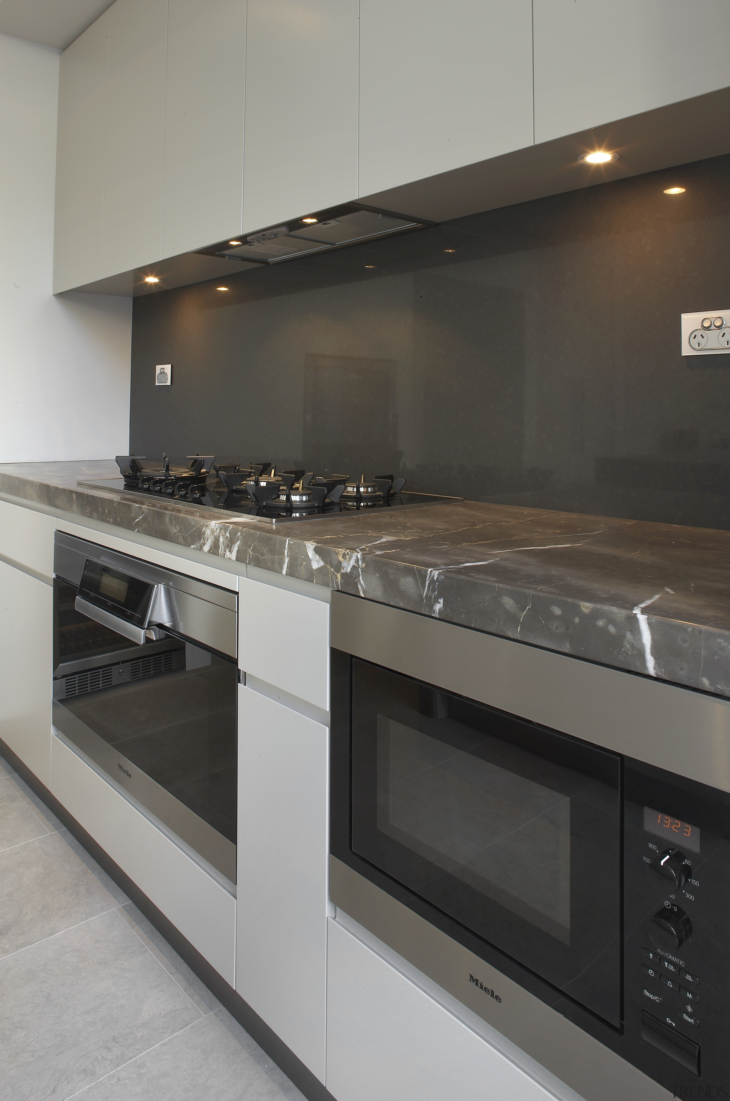 Grey and brown marble island benchtop, white walls, countertop, home appliance, interior design, kitchen, kitchen appliance, kitchen stove, oven, gray, black