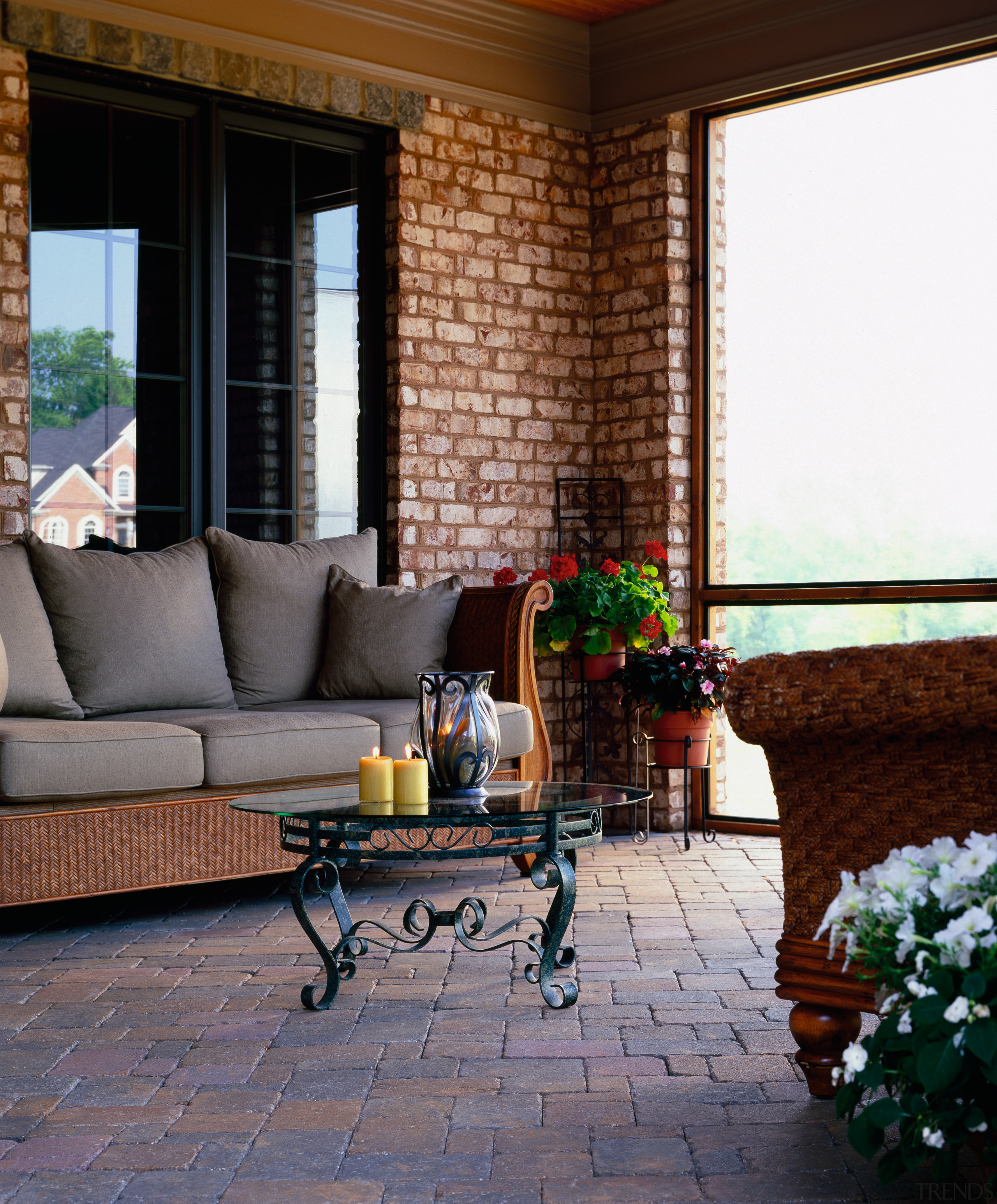 Conservatory with paved floor, brick walls and woven floor, flooring, furniture, home, interior design, living room, outdoor structure, patio, porch, room, wall, window, gray, black